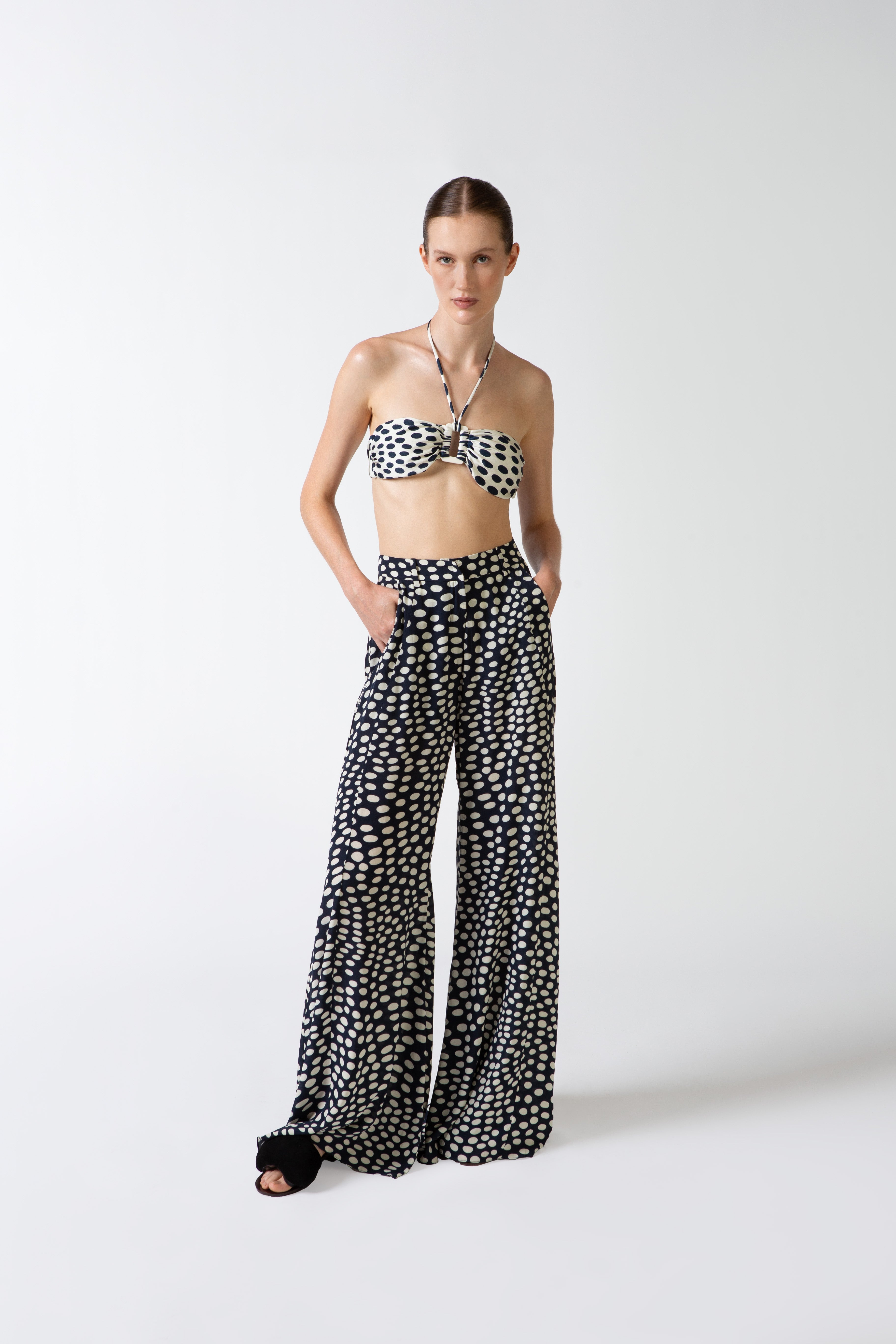 Model wearing the Pois Wide-Leg Pants navy front from the HS25 with 100% viscose styled for a beach look.