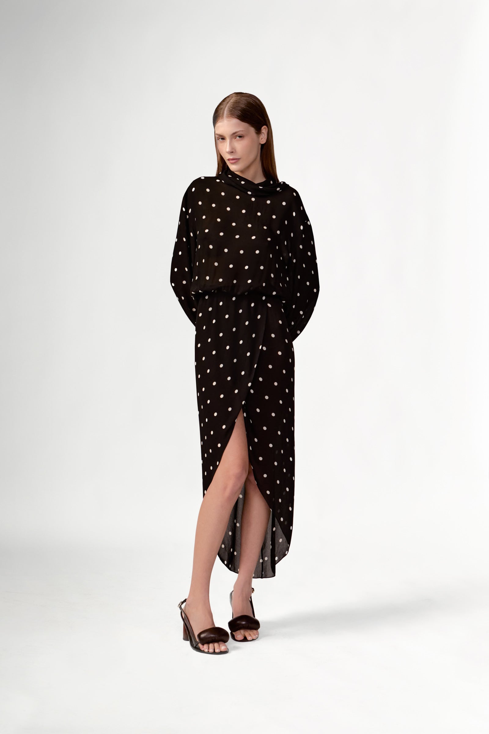 Model wearing the Polka Dots Long Sleeve Maxi Dress look showcasing its black color on 100% Viscose fabric, styled for an evening look.