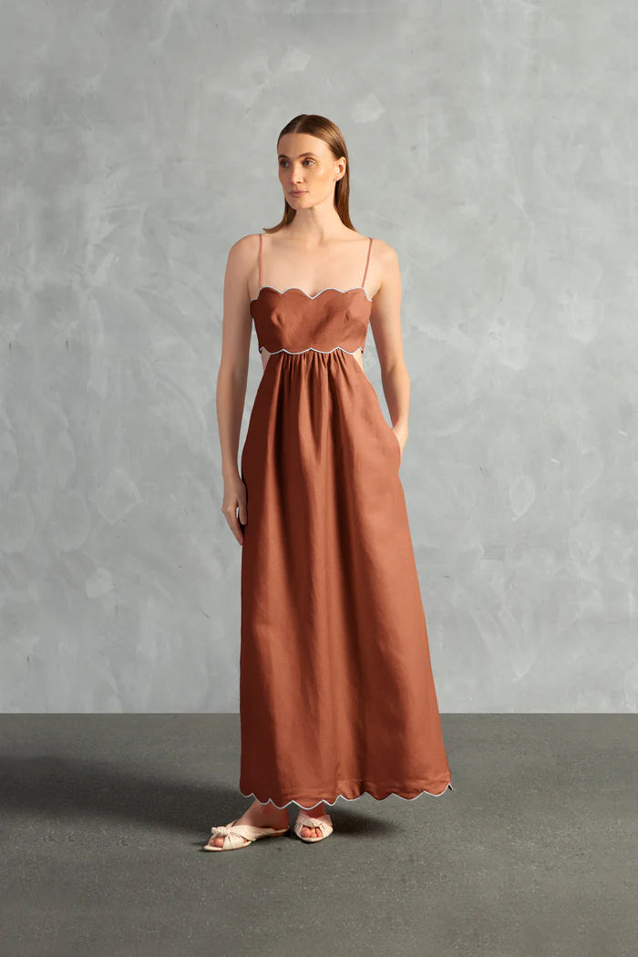Model wearing the Seashell Solid Cut-Out Long Dress Front color Cognac styled for a resort look
