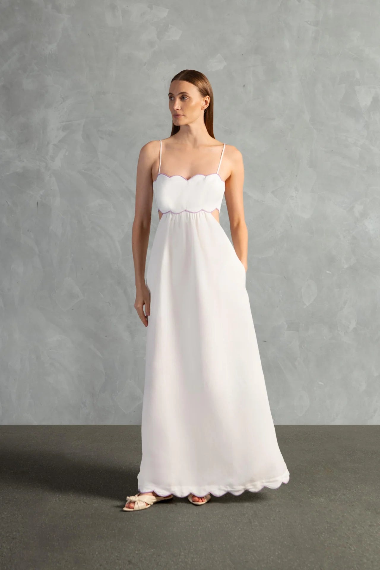 Model wearing the Seashell Solid Cut-Out Long Dress Front color Off White styled for a resort look