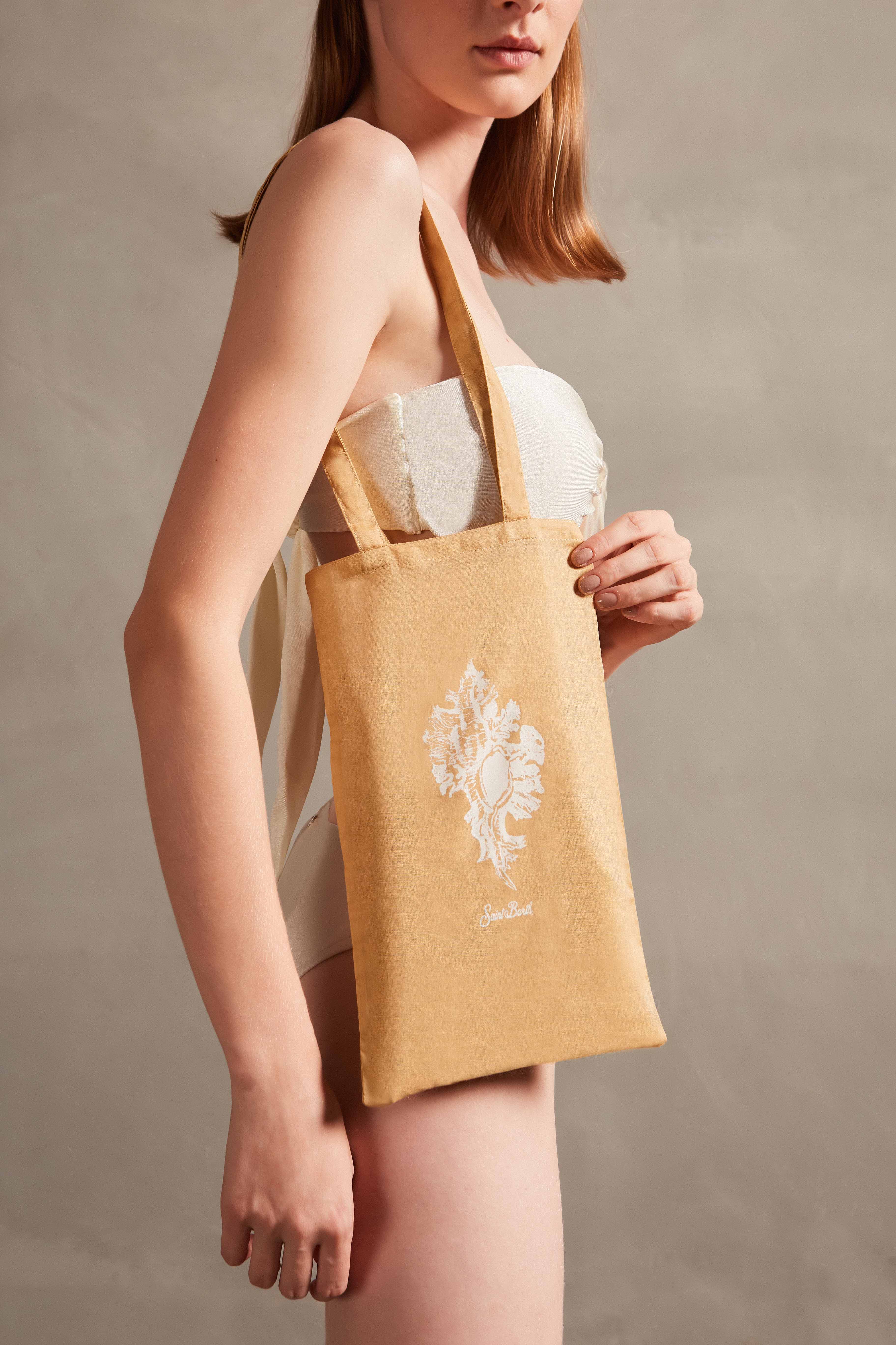 Model wearing the Seashell Print Bag Coral styled for a resort look