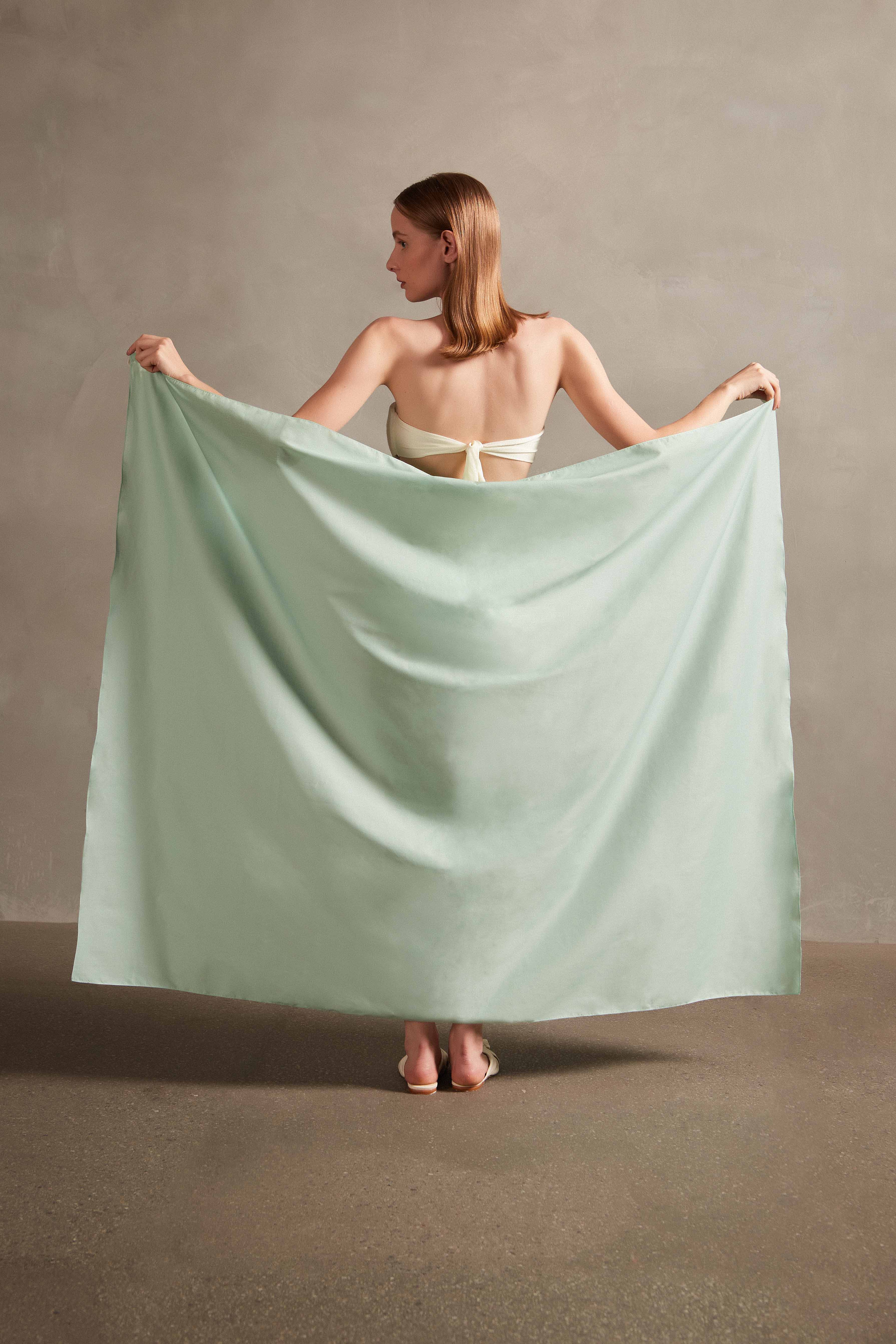 Model wearing the Seashell Print Panneaux Bag Turquoise styled for a resort look