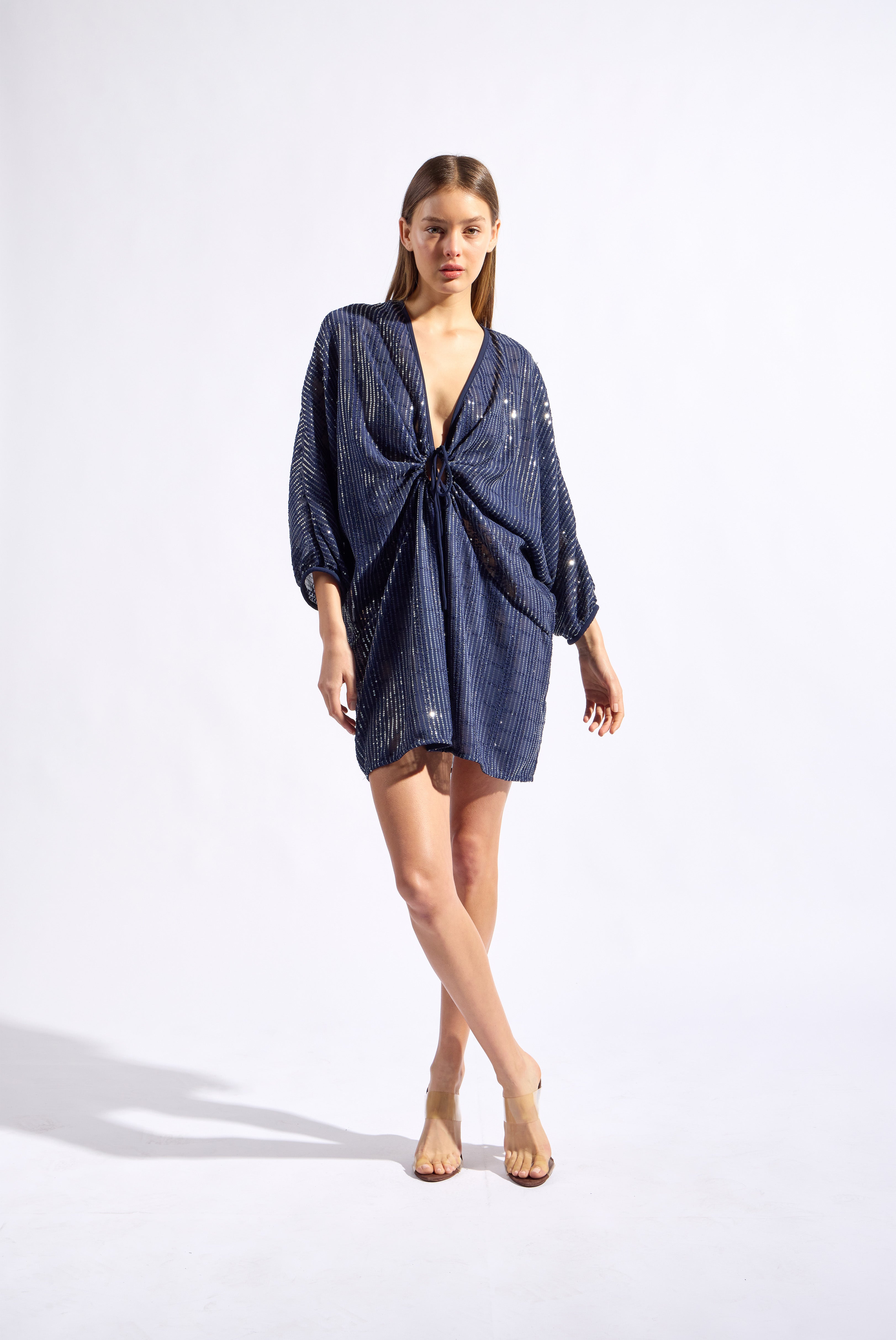 Model wearing the Sequin Front Tie Mini Kaftan front color navy made from 100% polyester, styled for a soiree look