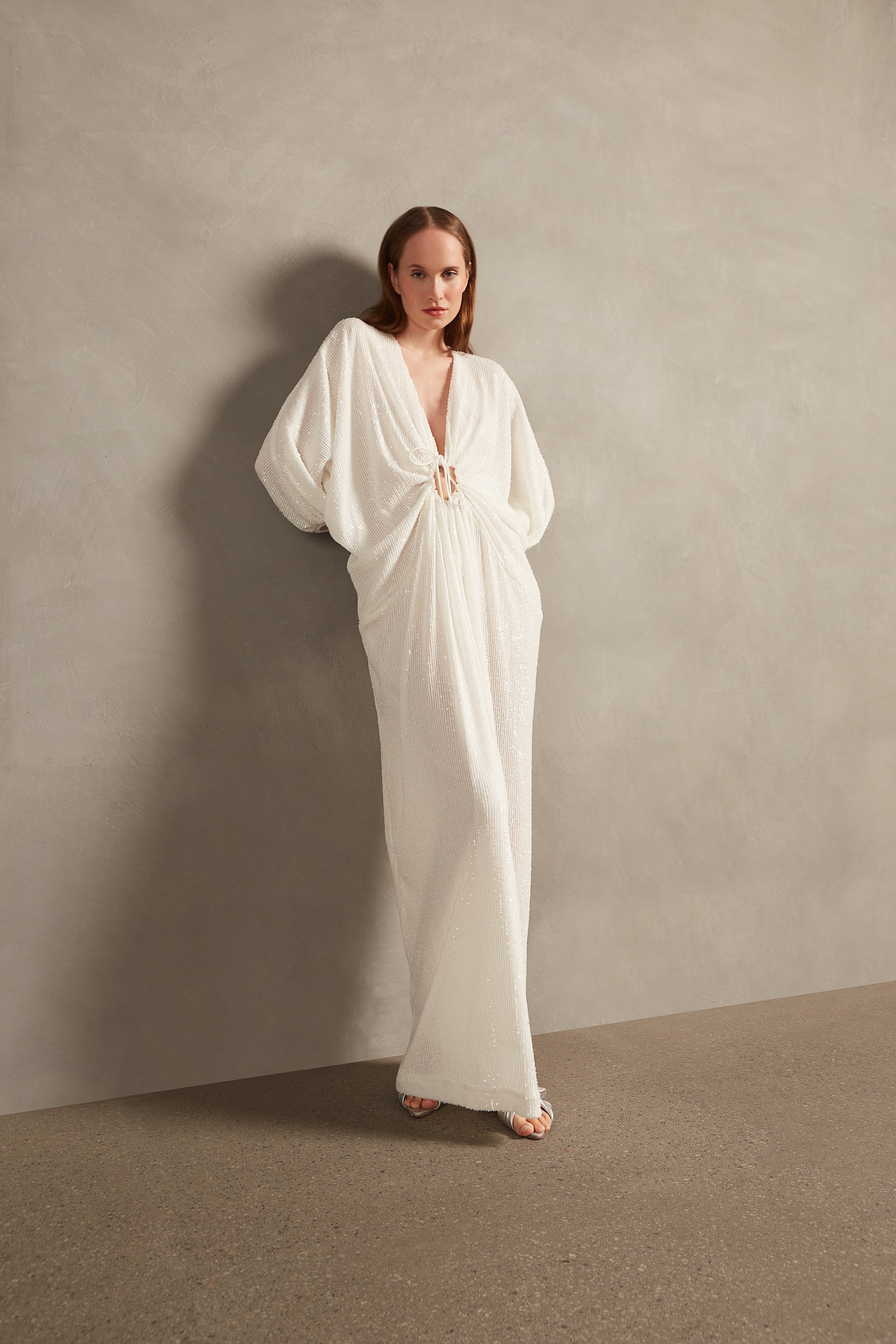 Model wearing the Sequins Long Kaftan showcasing the front of it's vintage style, with white Print, on a 98% Polyester 2% Elastane fabric