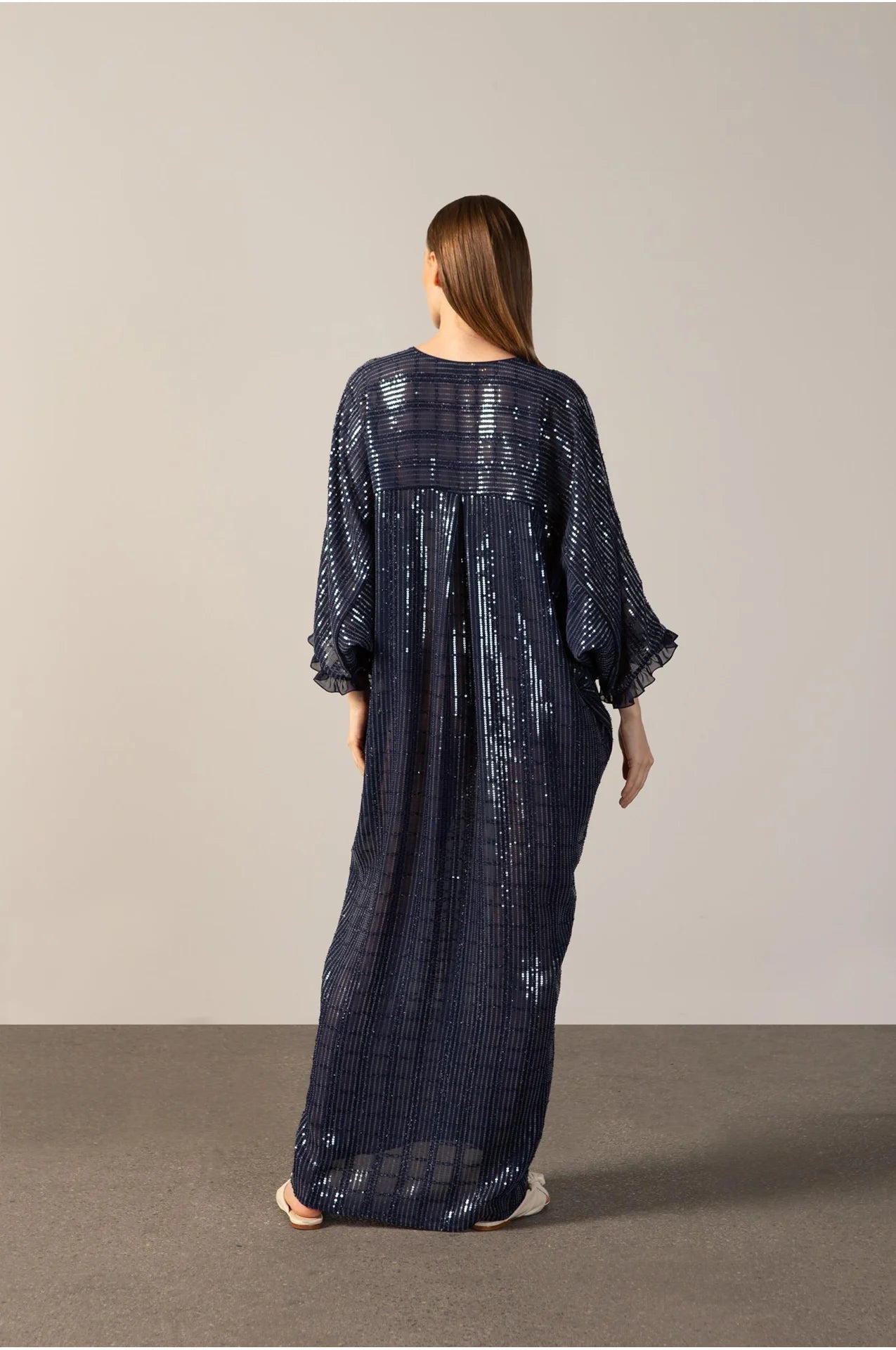 Model wearing the Sequins Maxi Kaftan back navy color front from the HS25 with 100% polyester styled for a drinks at the boat look.