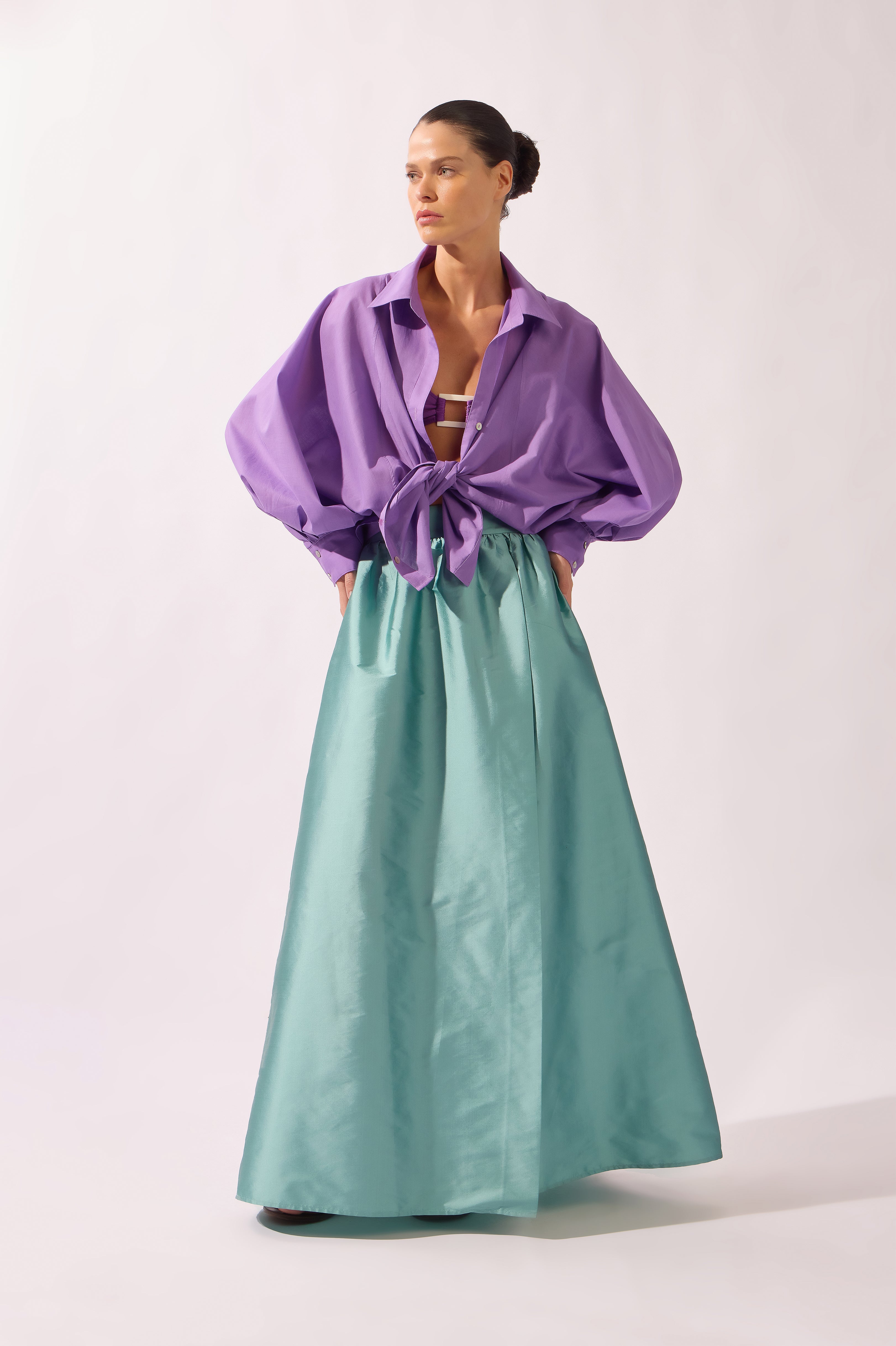 Model wearing the Side-Slit Maxi Skirt look color aquamarine made with 100% polyetser, styled for an post-beach look