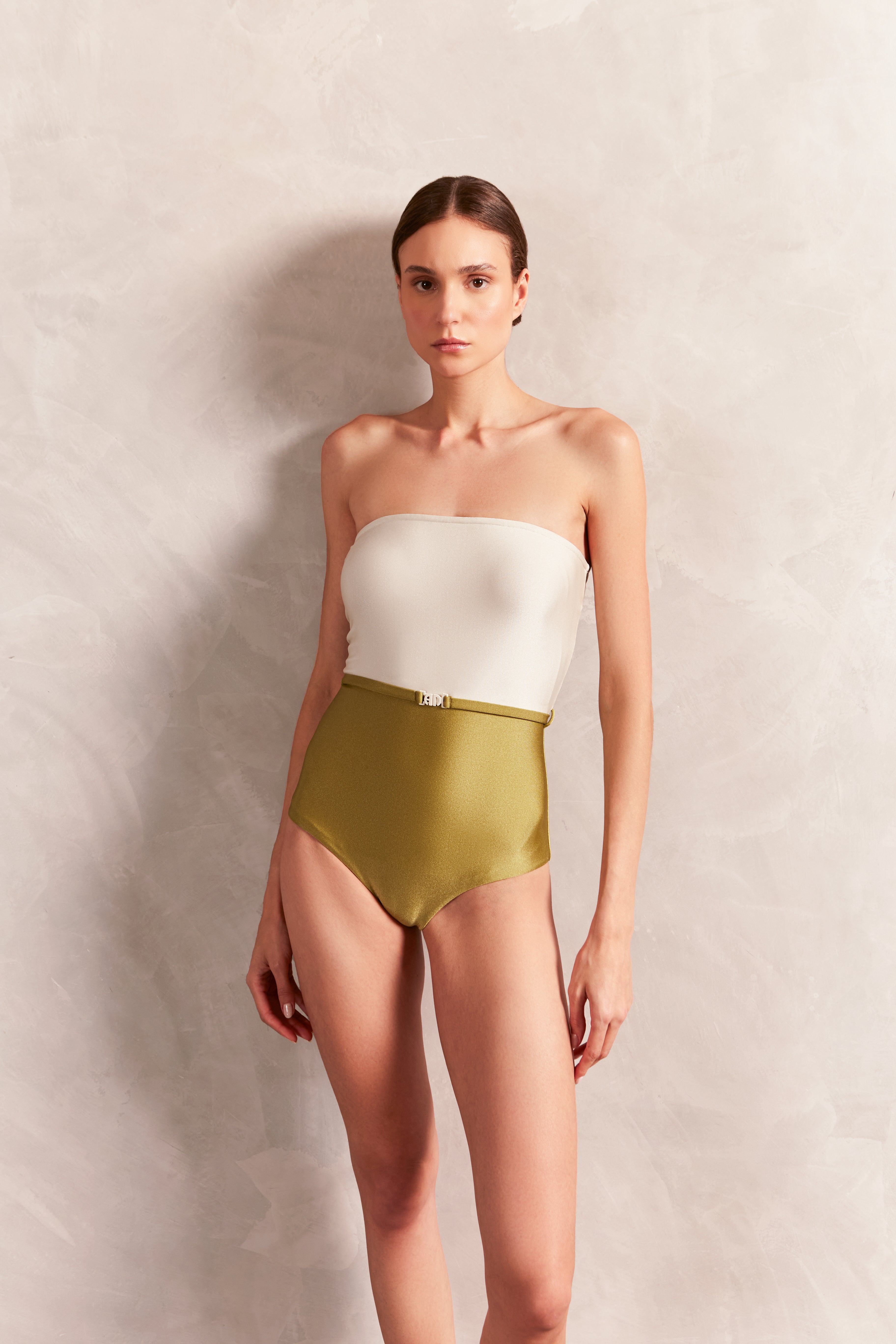 Model wearing the Solid AD Strapless Swimsuit Front showcasing its Off White and Green color on 85% Polyamide 15% Spandex fabric, styled for a beachwear look.