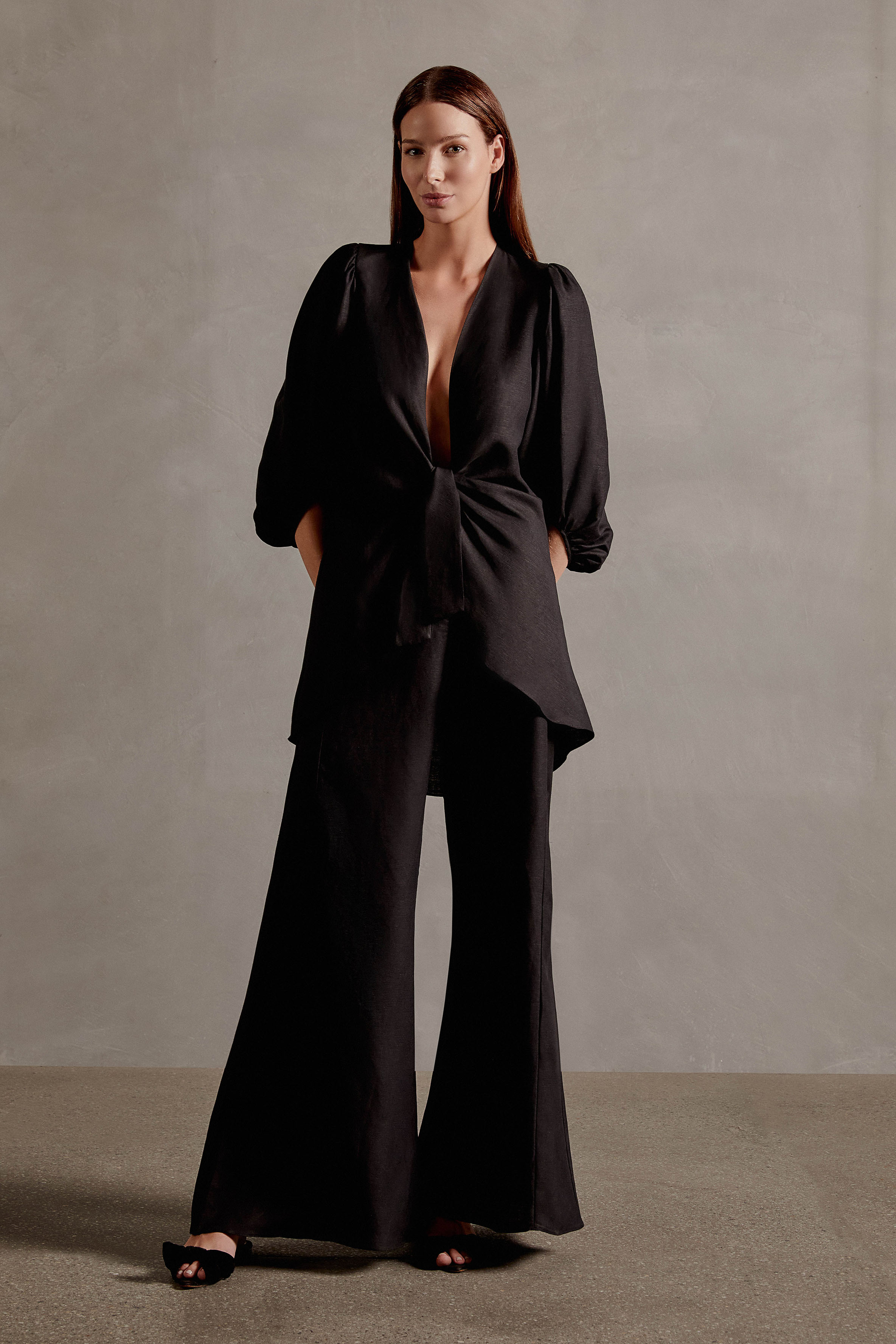 Model wearing the Solid Shirt With Voluminous Sleeves color black front with 100% linen fabric, styled for a dinner look.