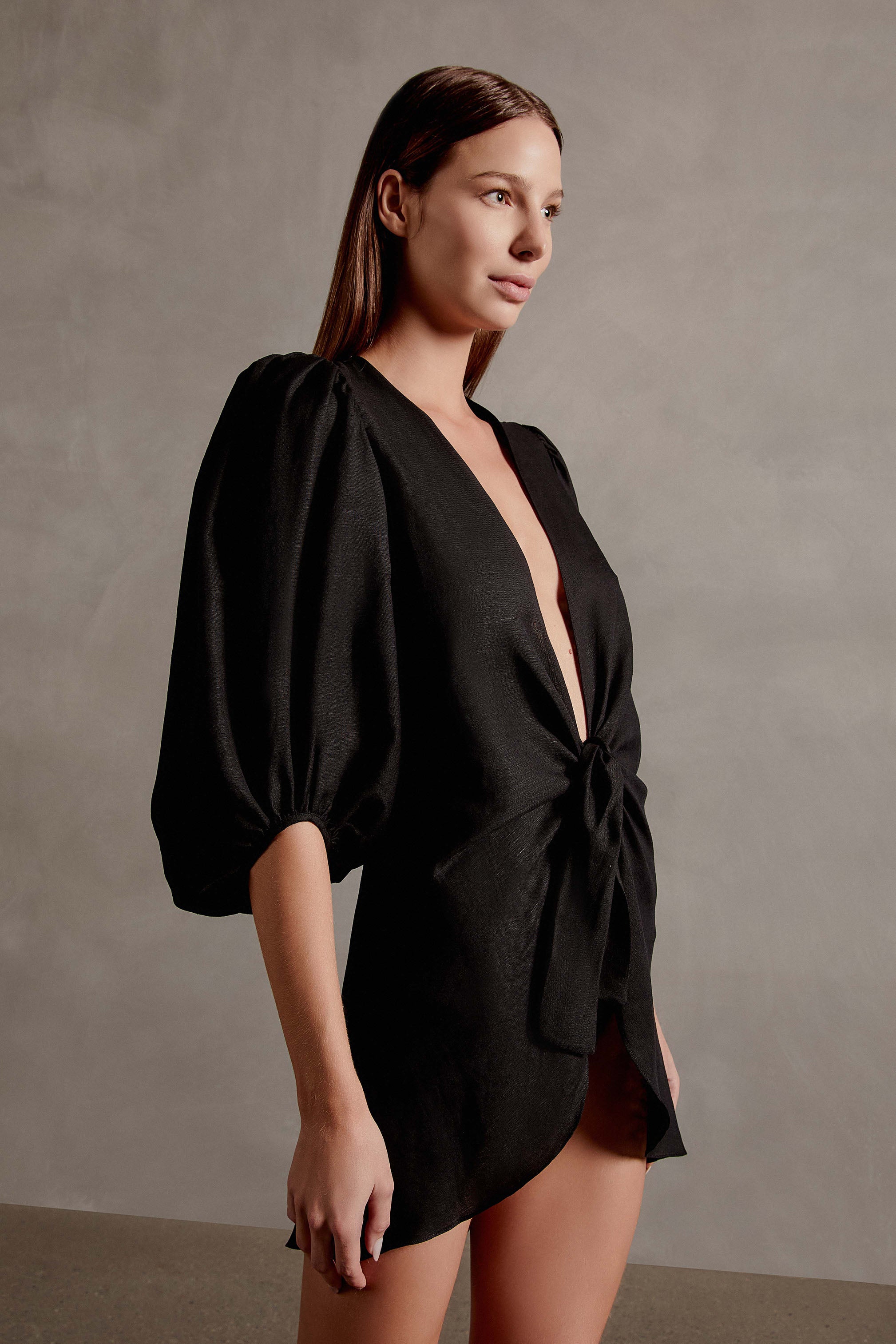 Model wearing the Solid Shirt With Voluminous Sleeves color black front with 100% linen fabric, styled for a resort look.