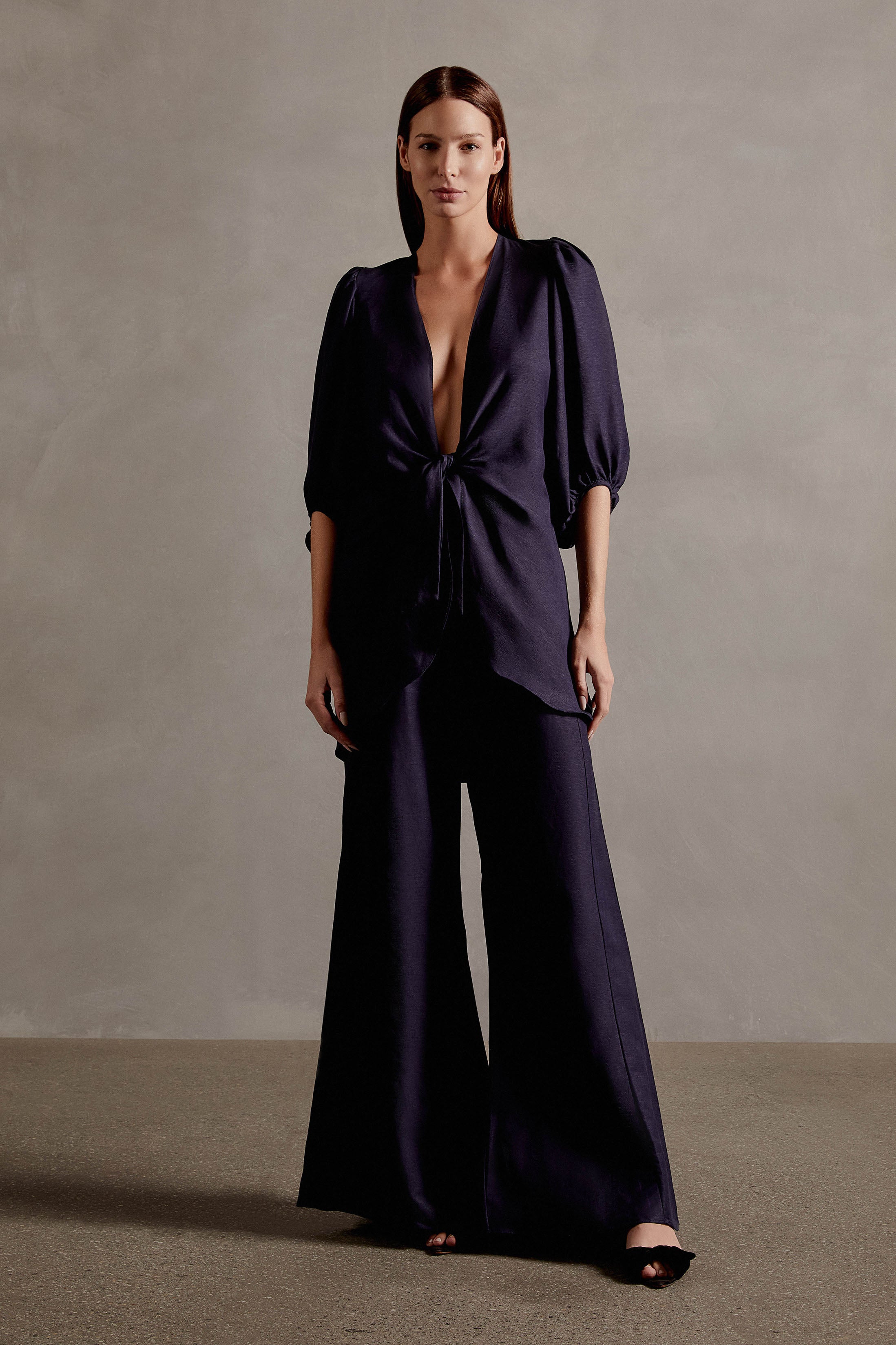 Model wearing the Solid Shirt With Voluminous Sleeves color dark blue front with 100% linen fabric, styled for a dinner look.