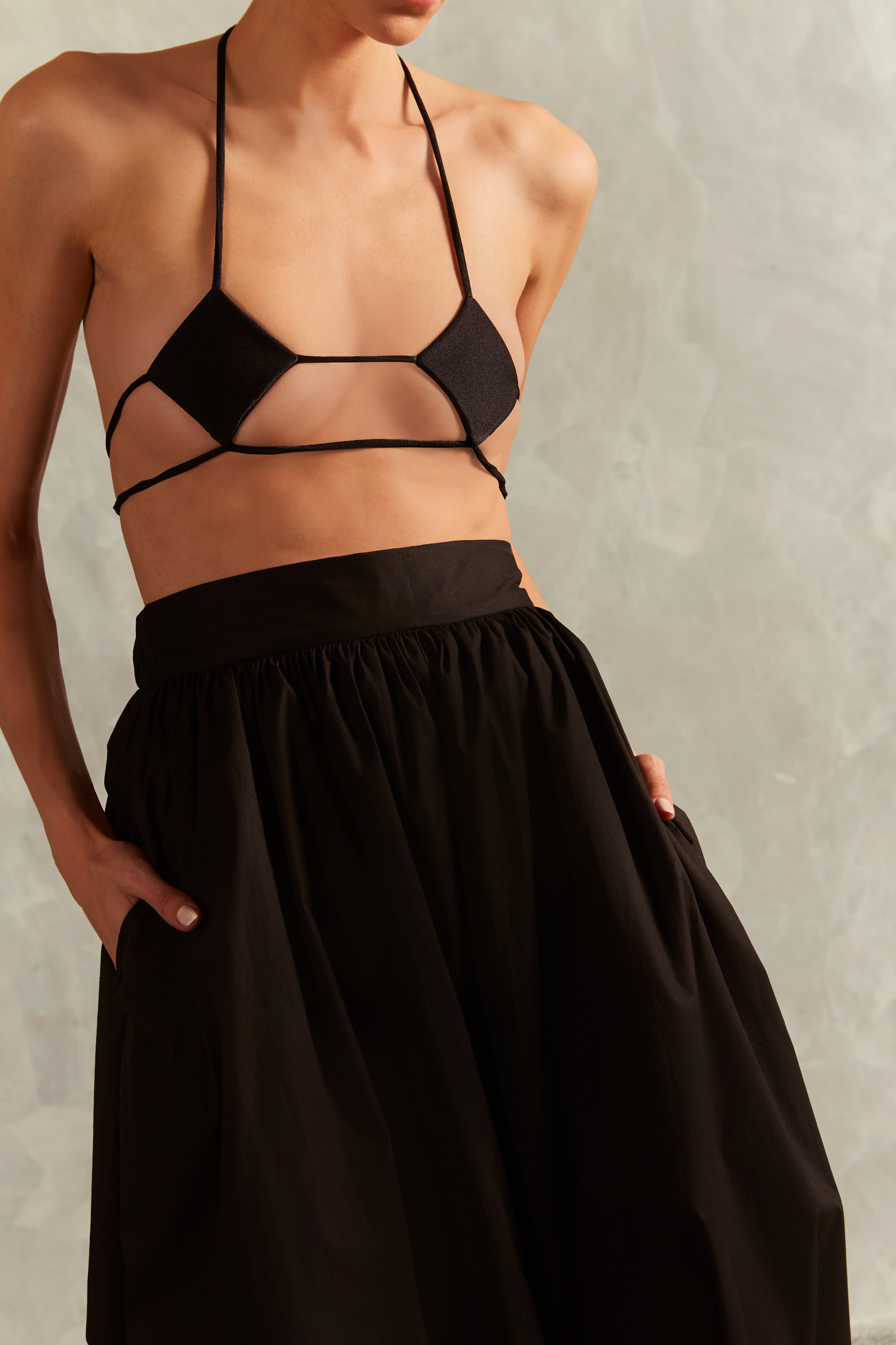 Model wearing the Solid Inamorata High-Waisted Nipple Bikini Concept showcasing its Black color on 85% Polyamide 15% Elastane fabric, styled for a beachwear look.