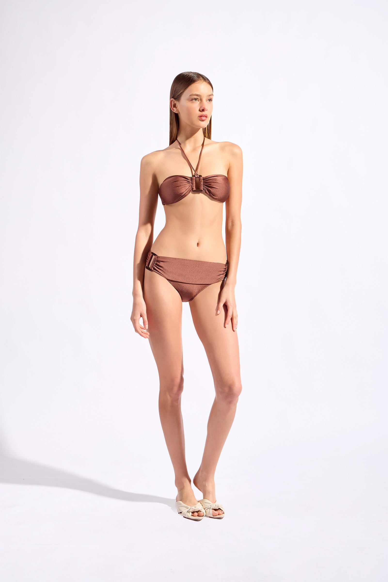 Model wearing the Solid Bandeau Bikini color cappuccino, styled for a beach look