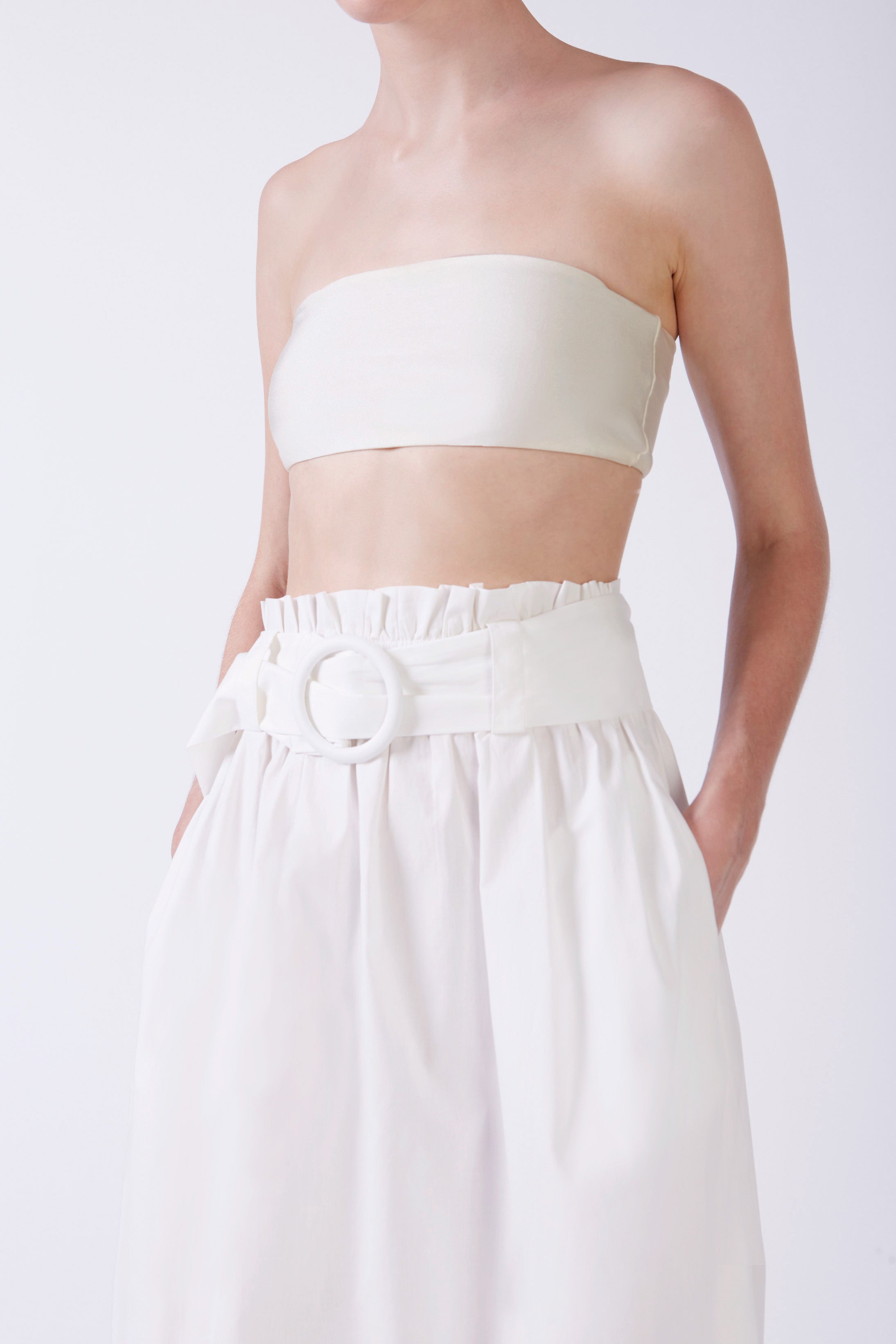 Model wearing the Solid Belted Long Skirt color off white detail styled for a resort look.