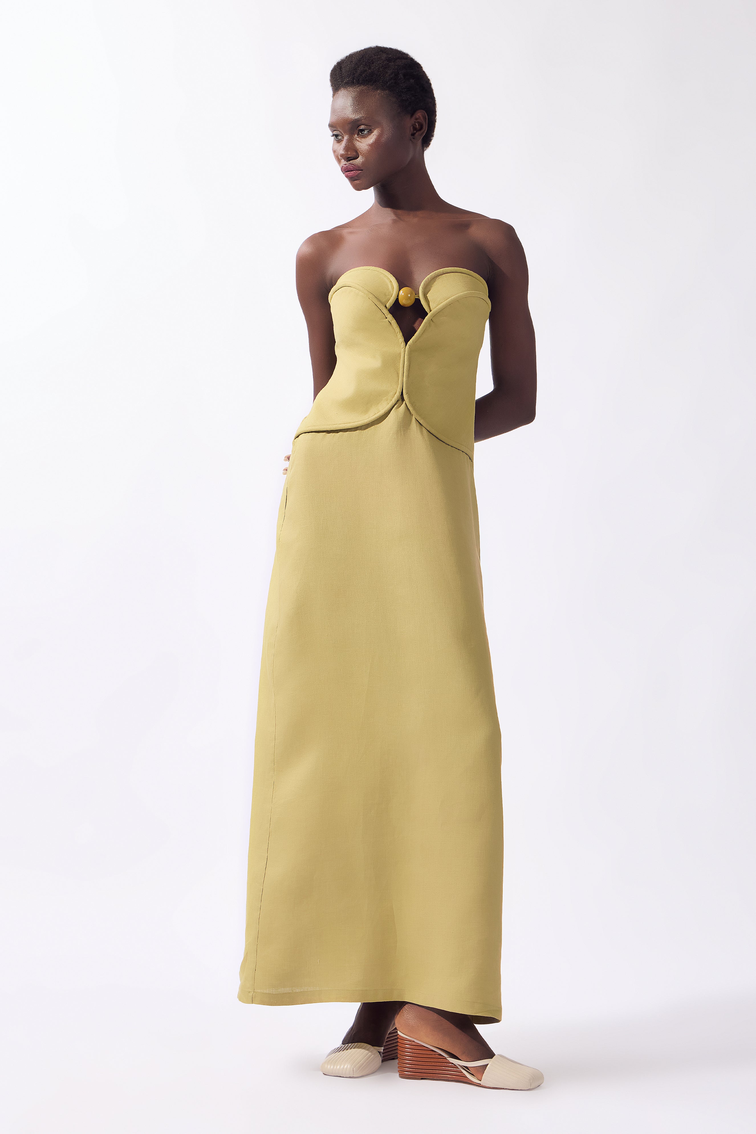 Model wearing the Solid Corset Maxi Dress look color pistachio, made from 100% linen, styled for night look