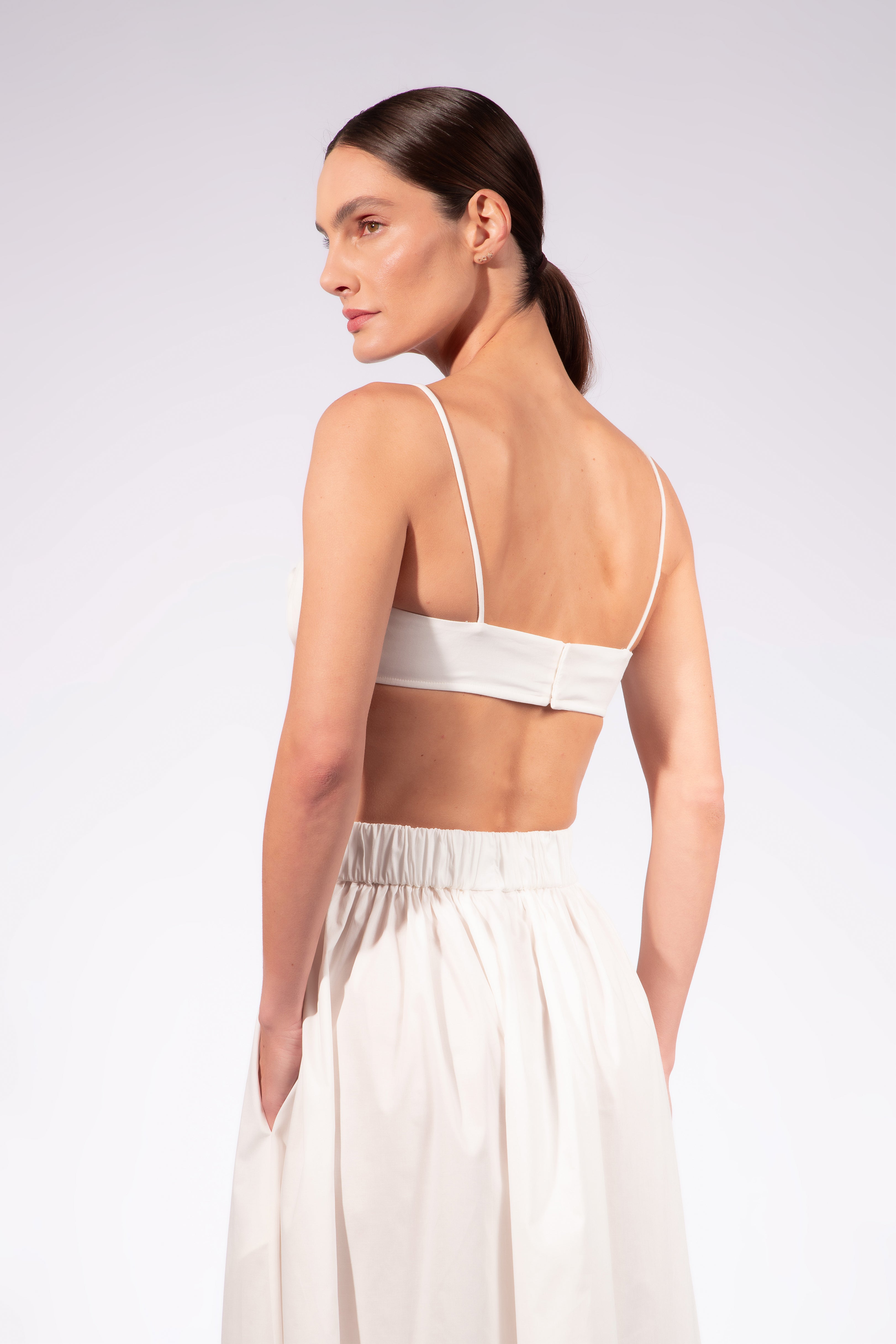 Model wearing the Solid Maxi Skirt detail back detail color off white made with 98% Cotton 2% Elastane, styled for resortwear look