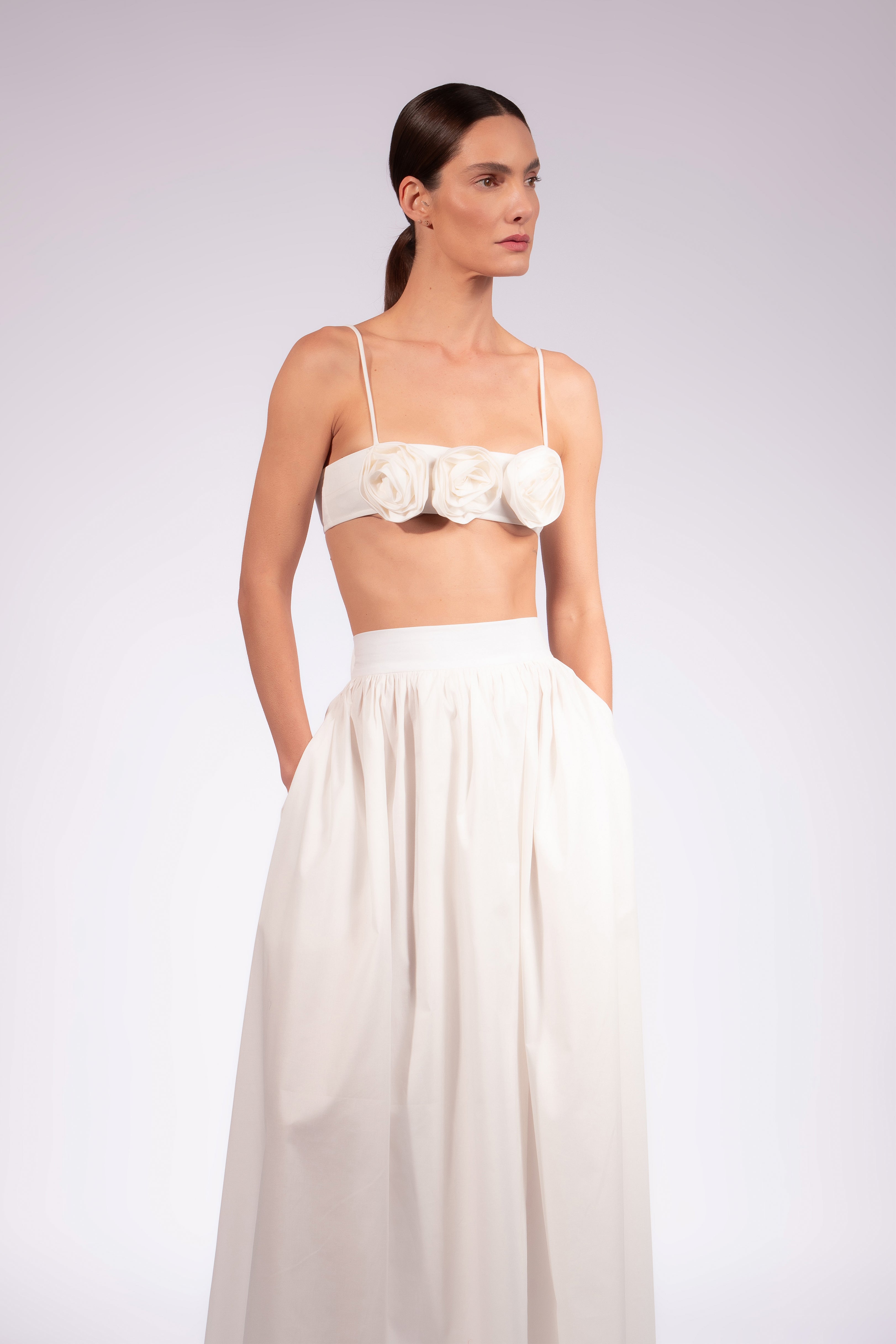 Model wearing the Solid Maxi Skirt detail front color off white made with 98% Cotton 2% Elastane, styled for resortwear look