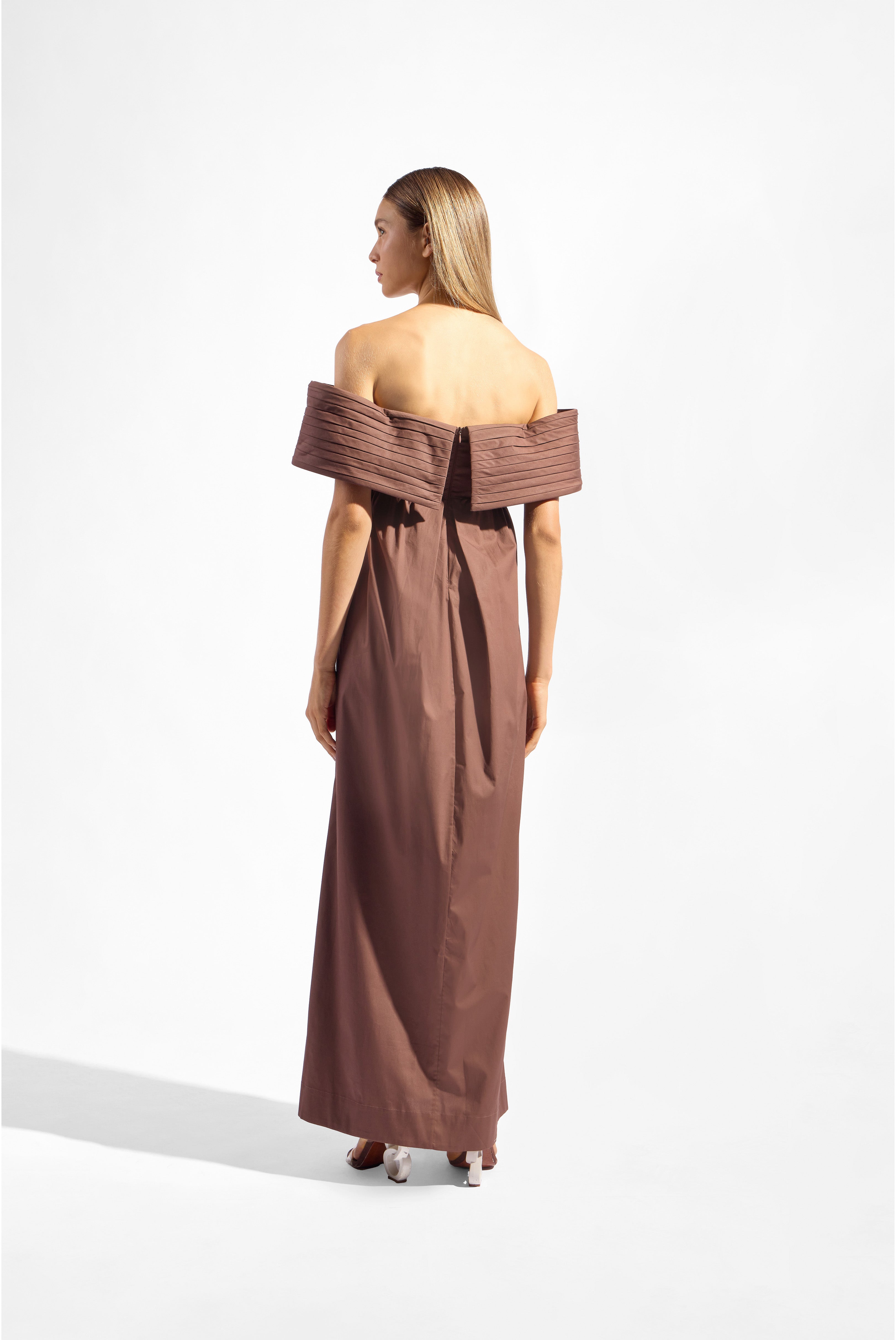 Model wearing the Solid Off-The-Shoulder Maxi Dress color brown made from 97% cotton 3% elastane, styled for a party look