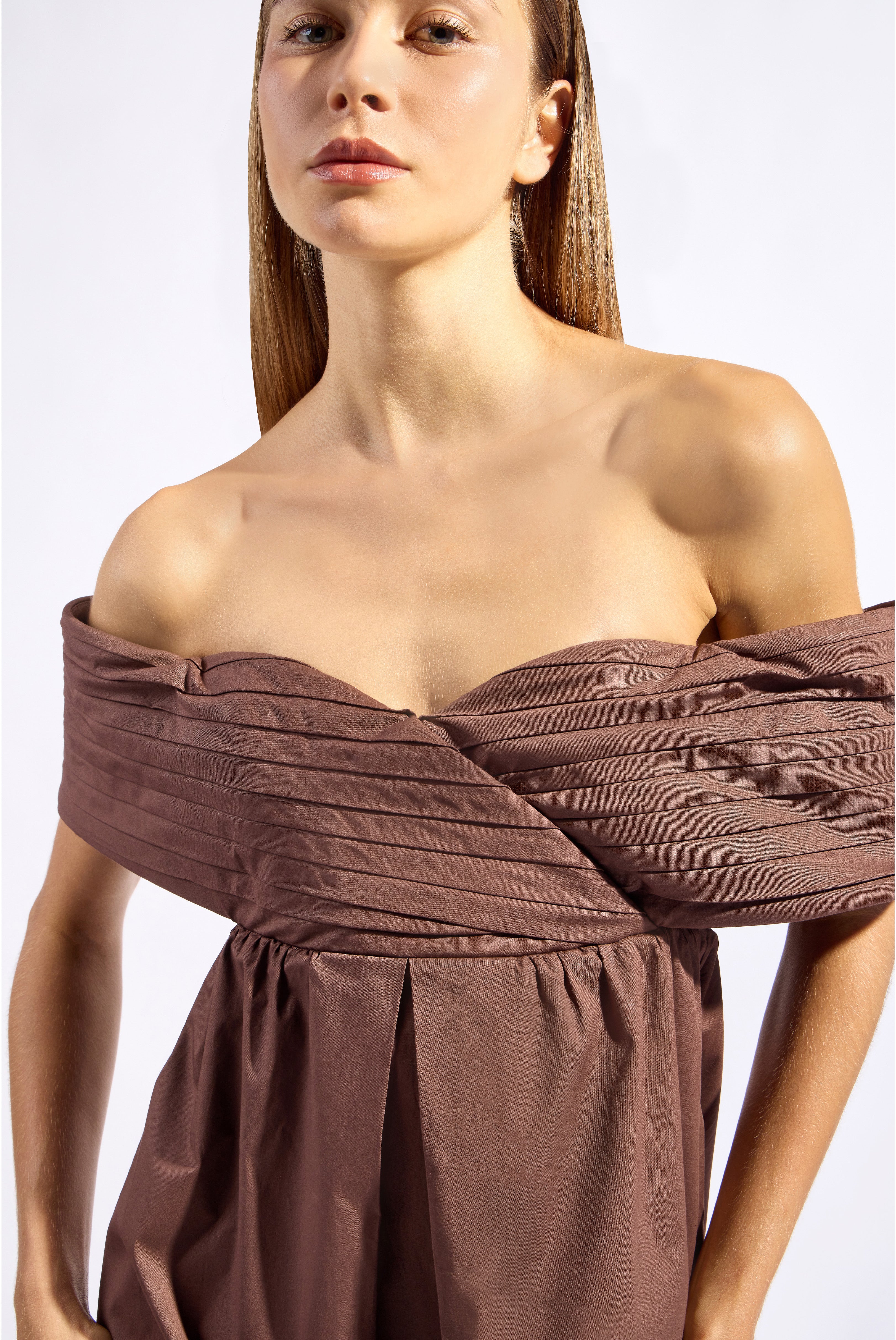 Model wearing the Solid Off-The-Shoulder Maxi Dress color brown made from 97% cotton 3% elastane, styled for a party look