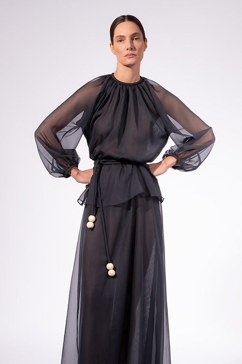 Model wearing the Solid Peplum Maxi Dress front color navy made with 100% Cotton, styled for resortwear look