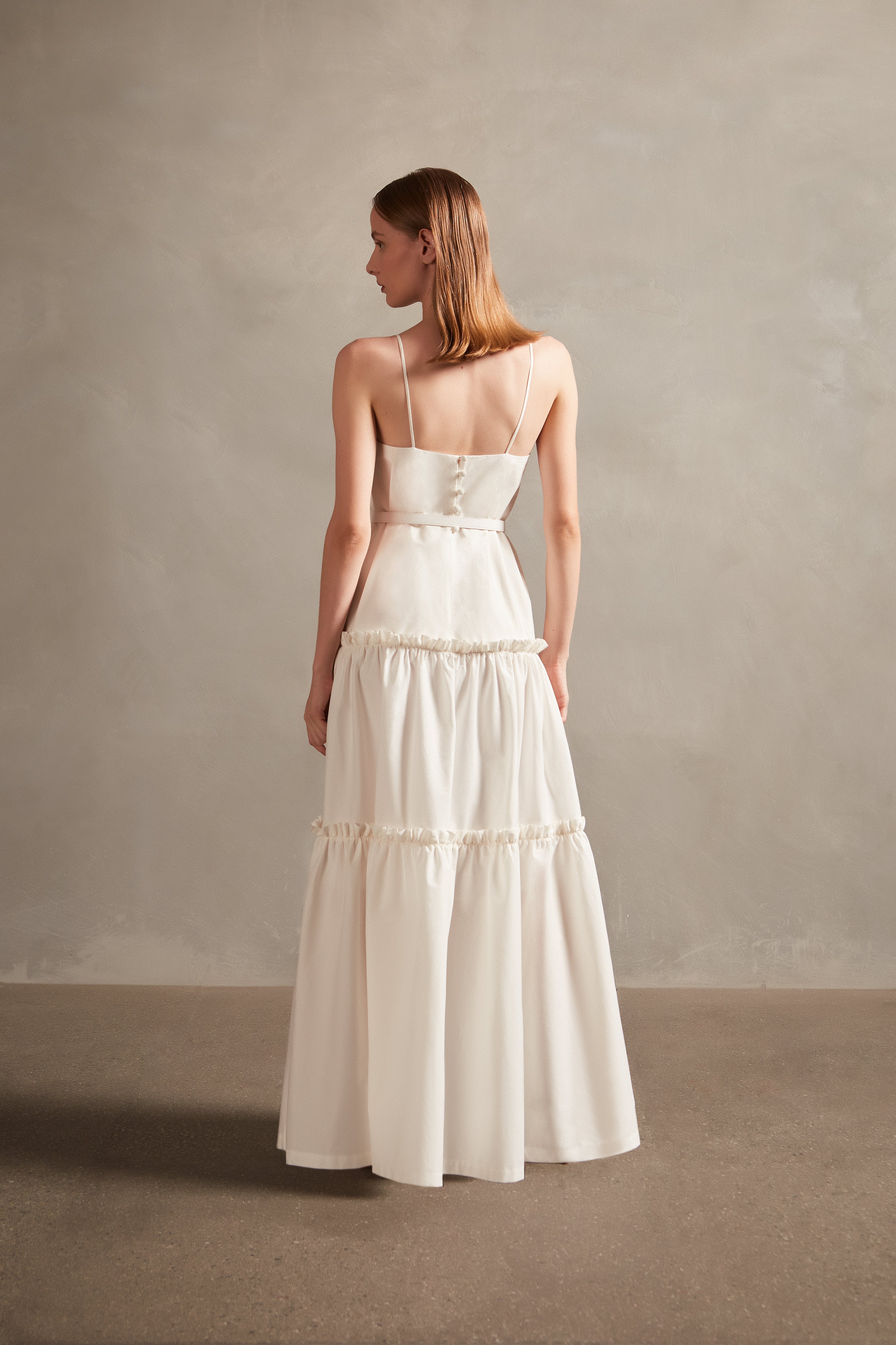 Model wearing the Solid Ruffled Long Dress in off white back, with 98% COTTON 2% ELASTANE, styled for a resort look