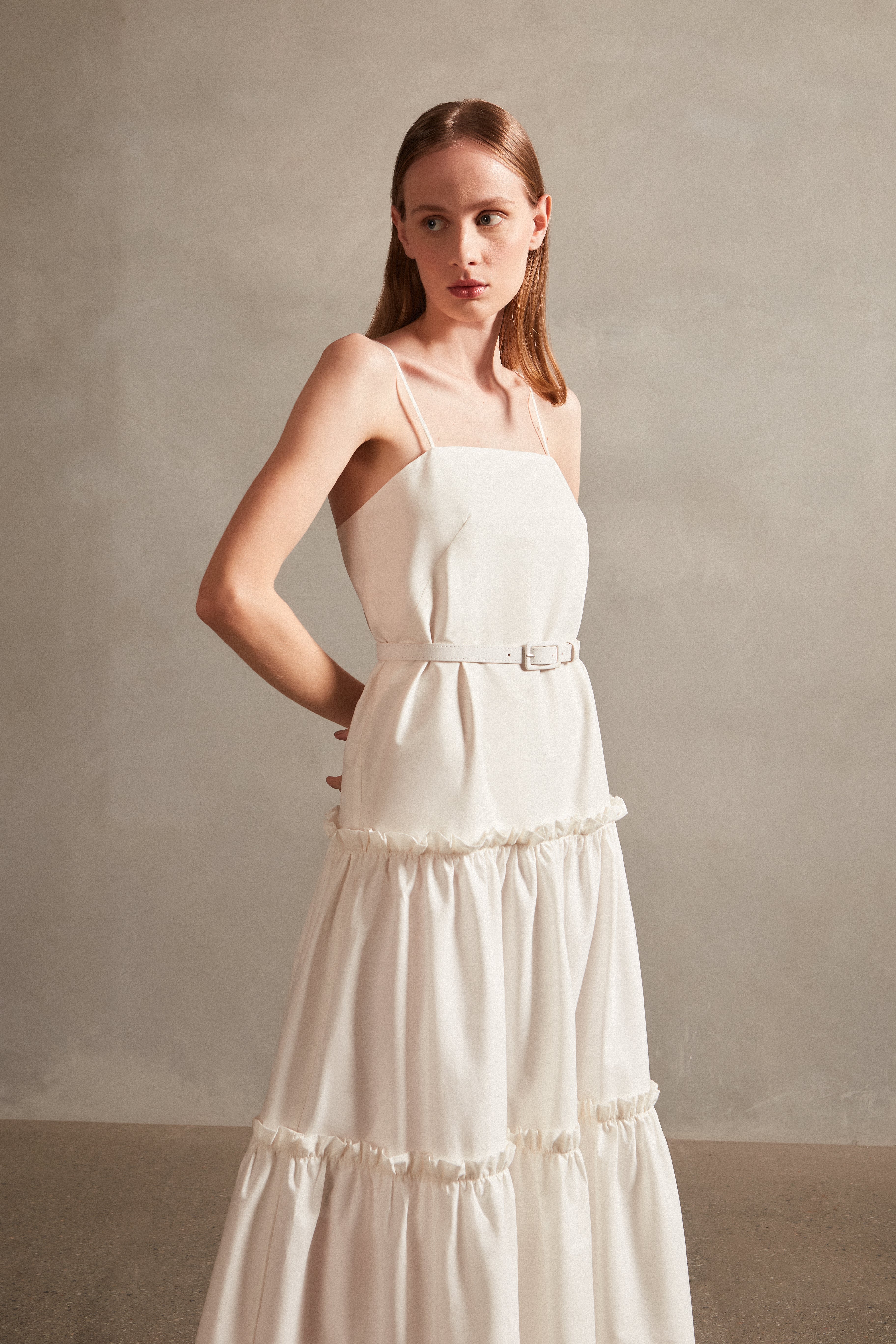 Model wearing the Solid Ruffled Long Dress in off white detail, with 98% COTTON 2% ELASTANE, styled for a resort look