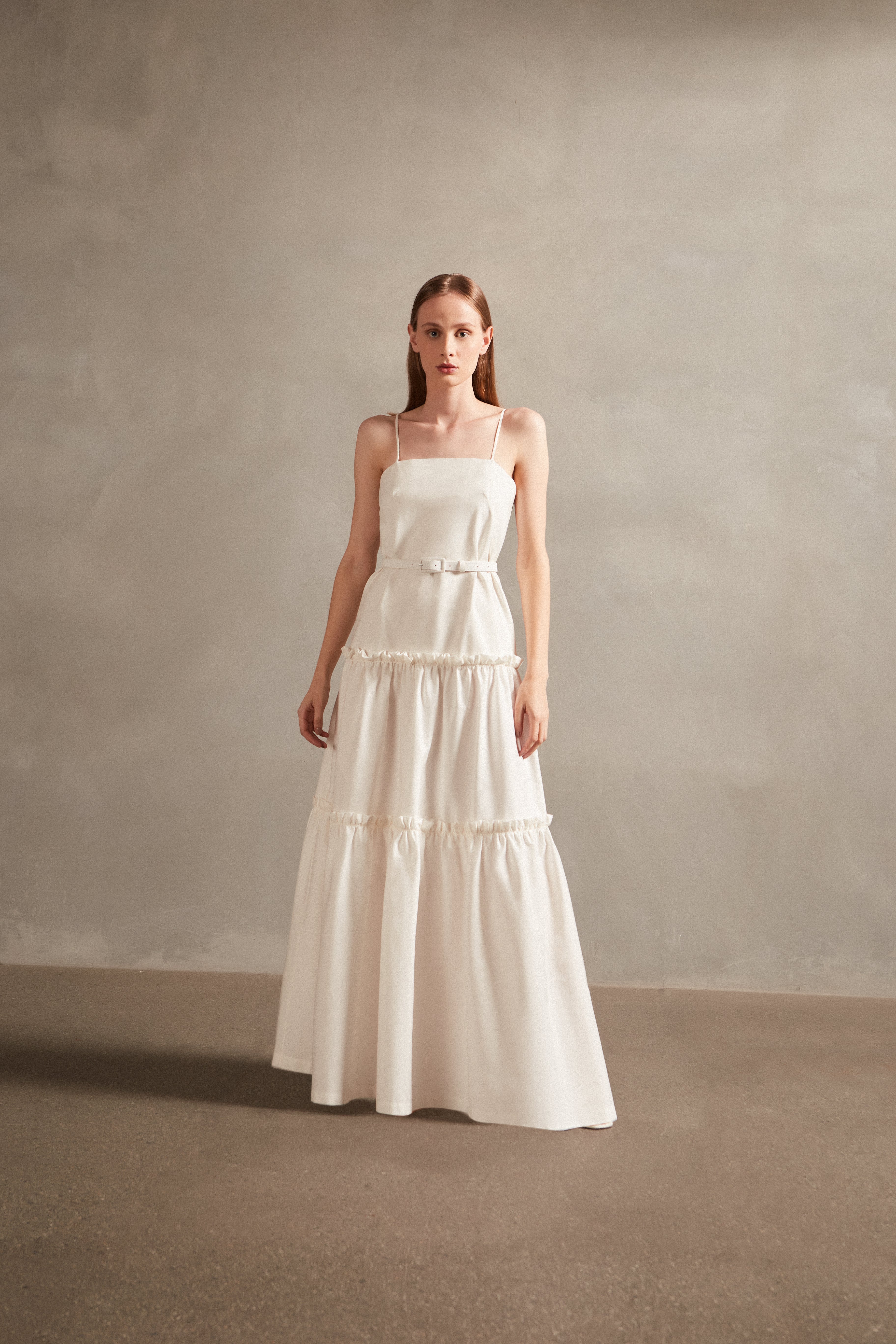 Model wearing the Solid Ruffled Long Dress in off white, with 98% COTTON 2% ELASTANE, styled for a resort look