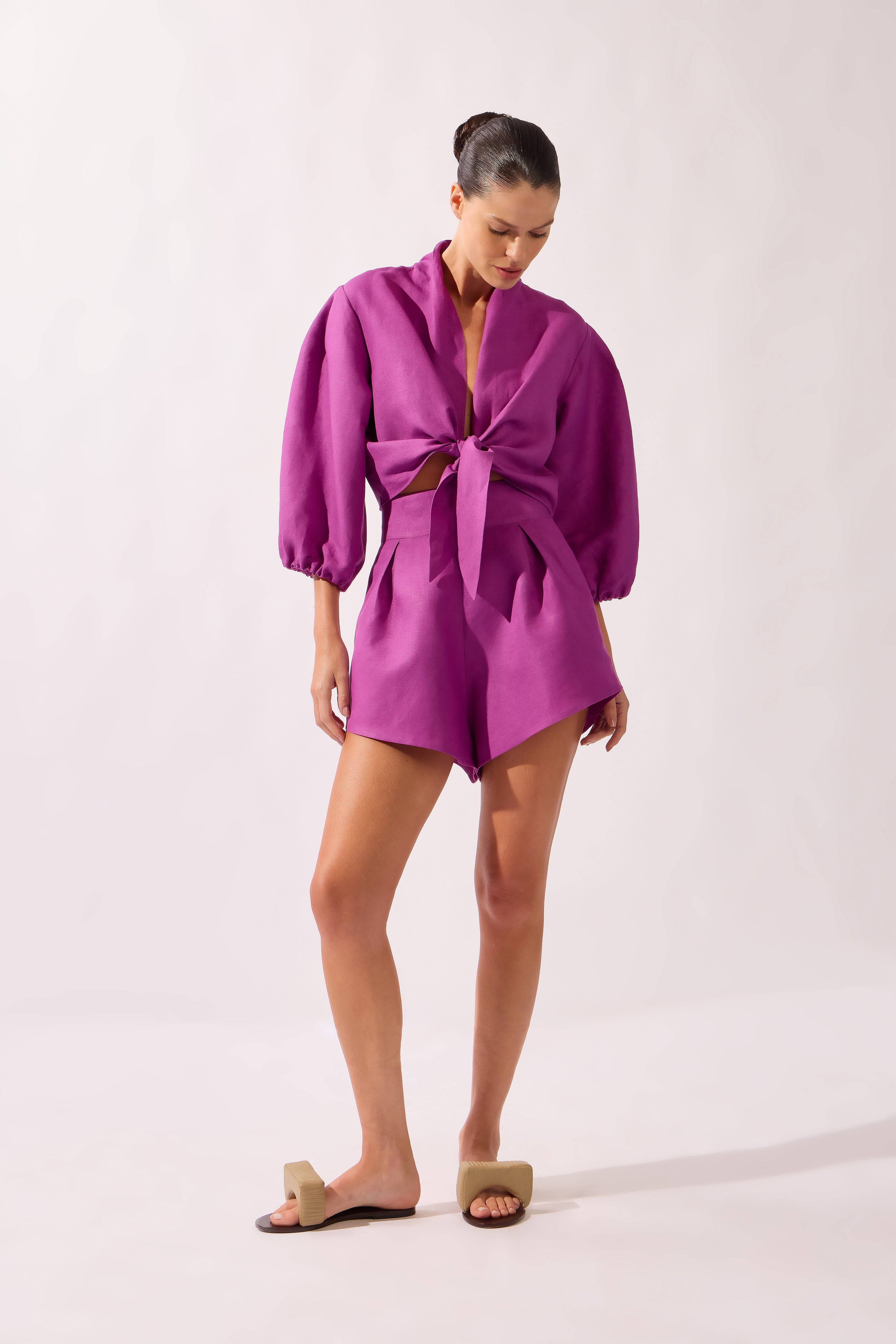 Model wearing the Tie-Front Crop Top front color purple, made from 55% linen 45% viscose, styled for a resort look
