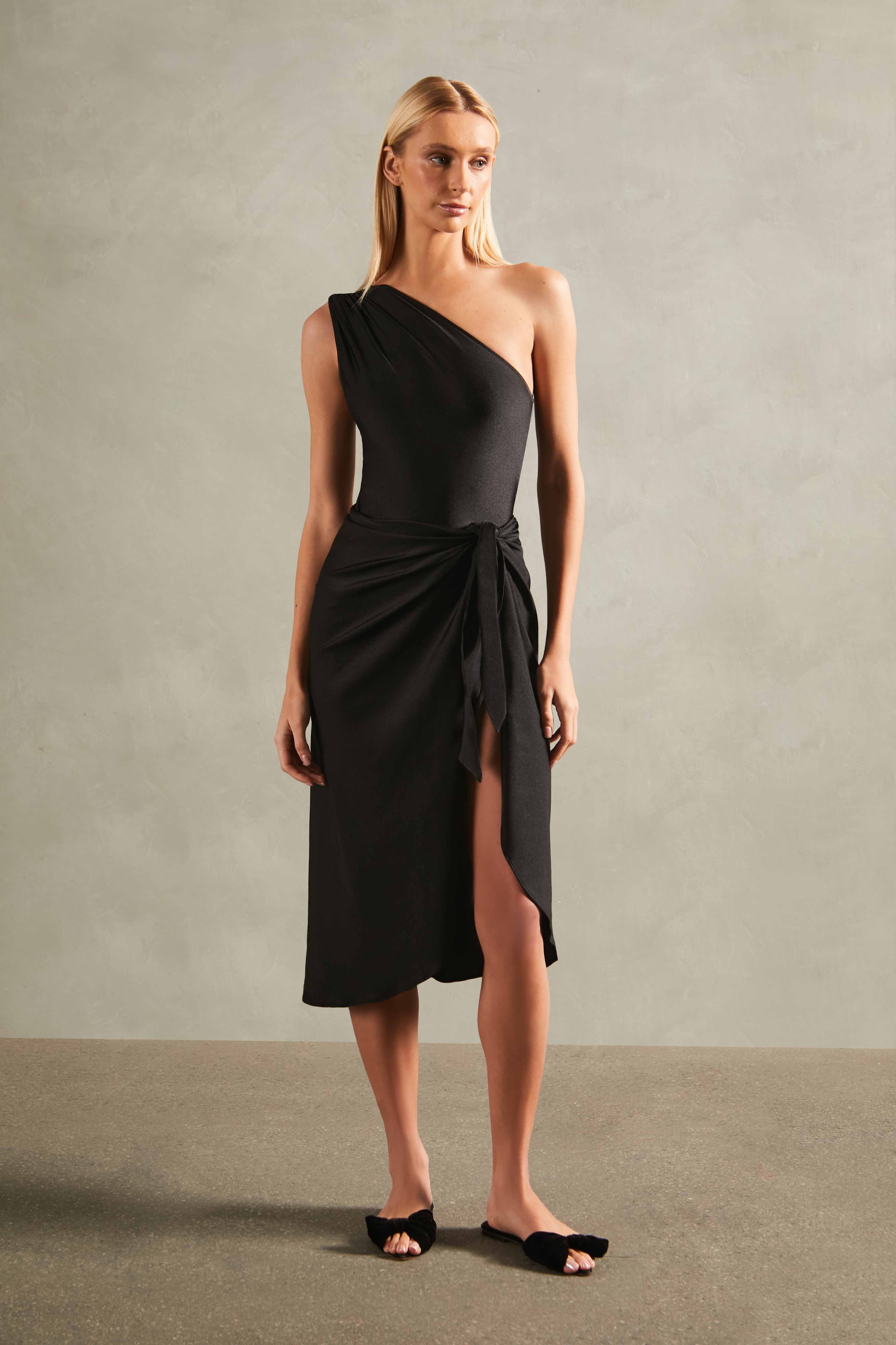 Model wearing the Timeless Pareo Skirt Front color black with 85% POLYAMIDE 15% SPANDEX fabric styled for a resortwear look