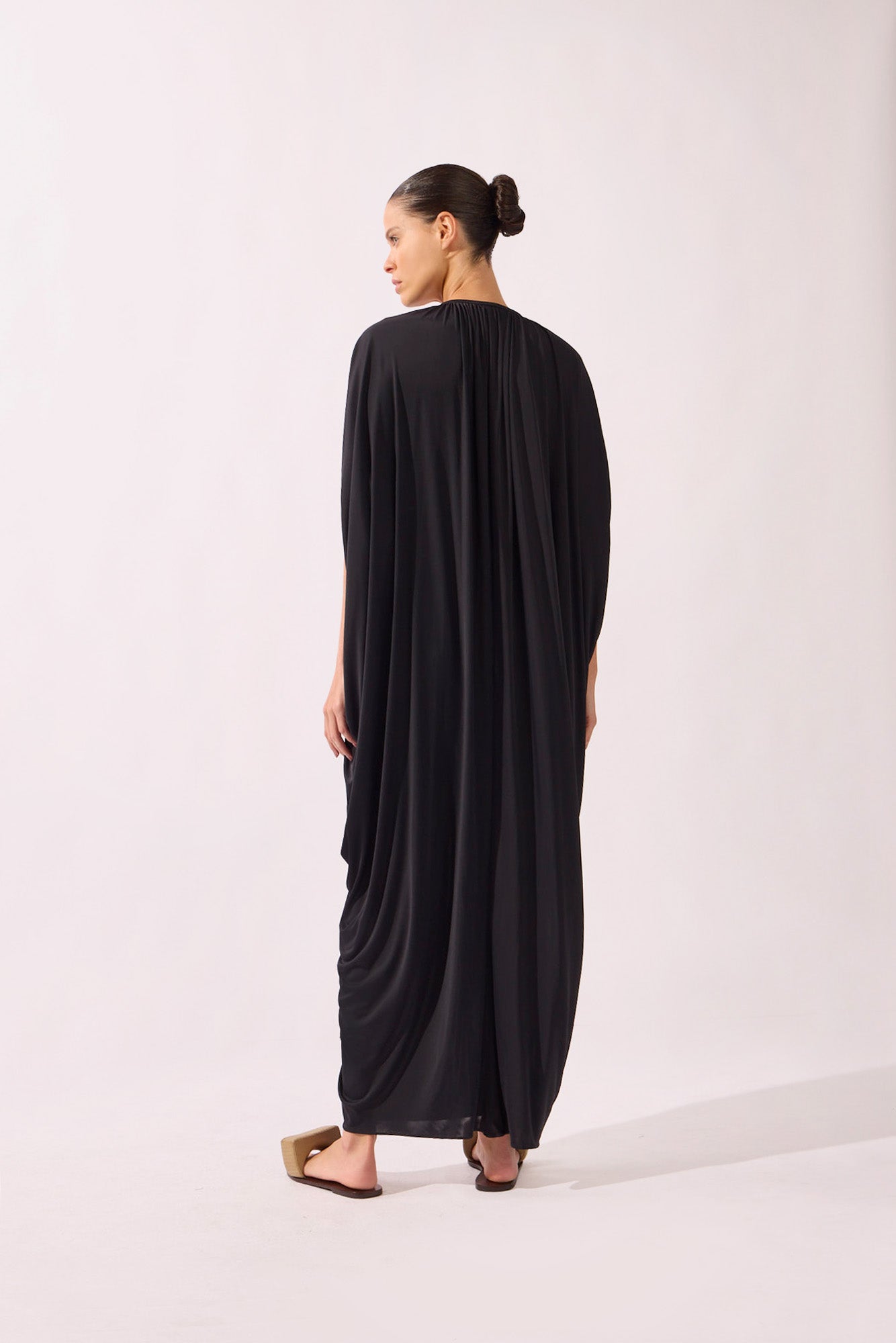 Model wearing the V-Neck Jersey Maxi Dress back color black, made from 100% polyamide, styled for a resort look