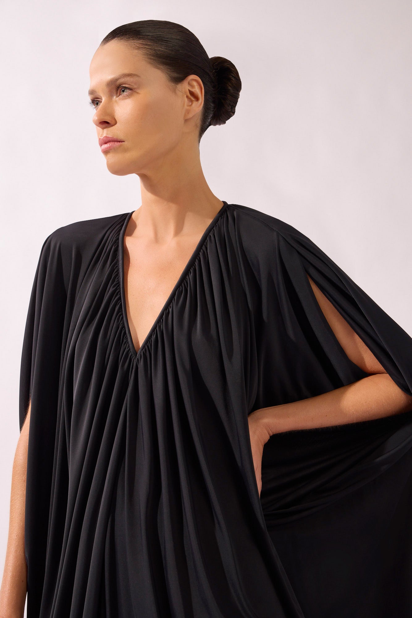 Model wearing the V-Neck Jersey Maxi Dress detail color black, made from 100% polyamide, styled for a resort look