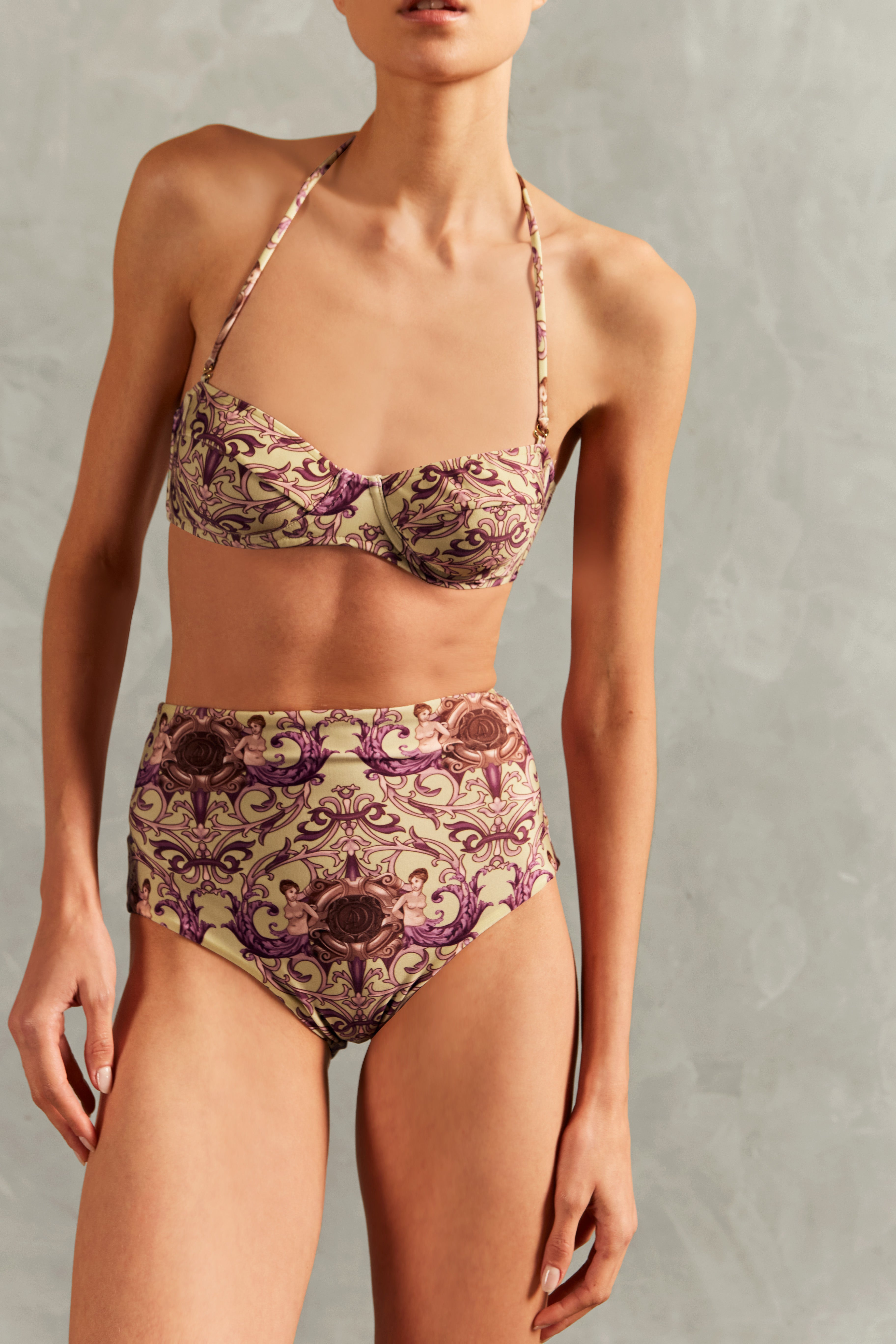 Model wearing the Vintage Citronelle High-Waisted Bikini Detail showcasing its Citronelle color on 85% polyamide 15% elastane fabric.
