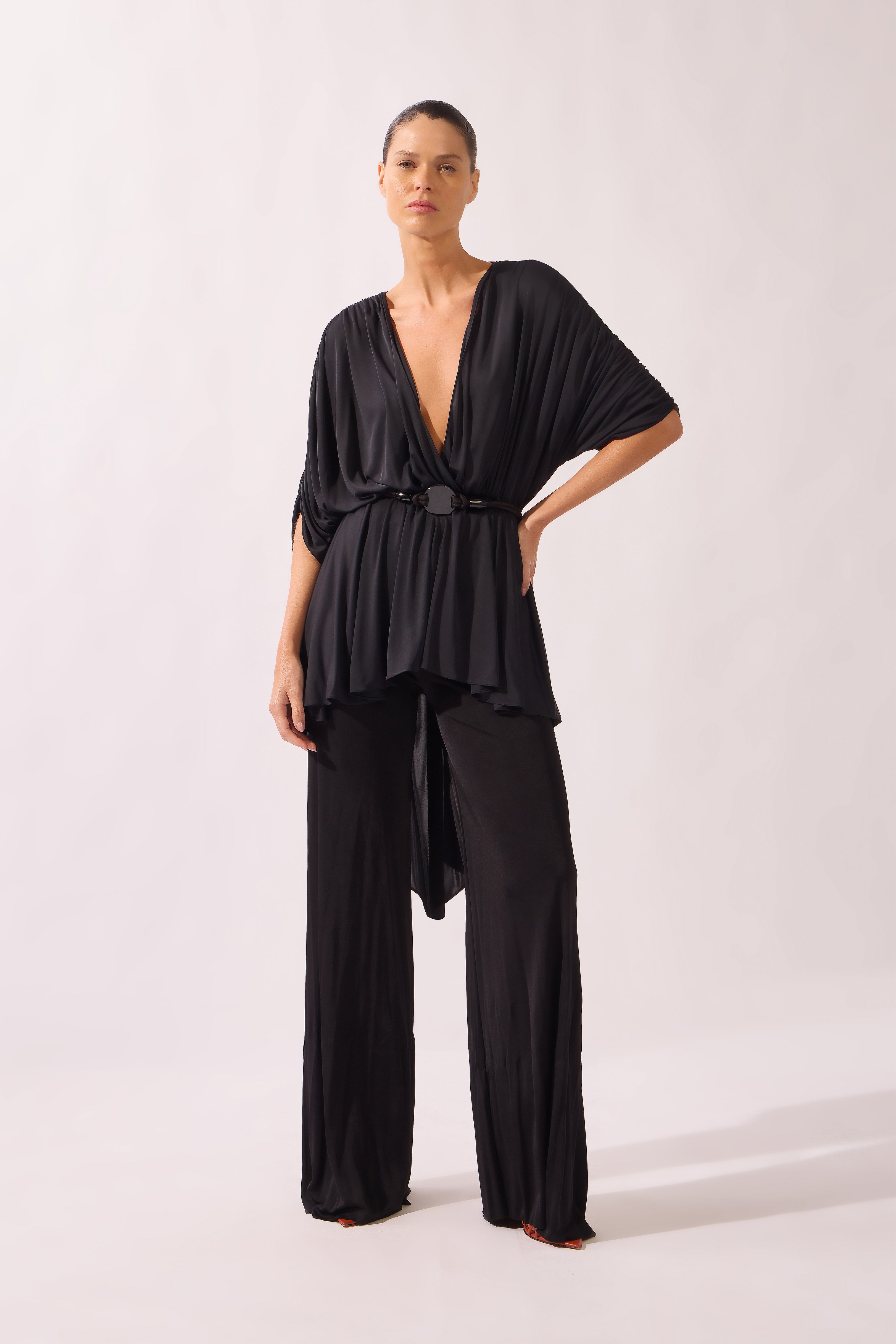 Model wearing the Wide-Leg Jersey Pants color black, made from 100% polysters, styled for a resort look