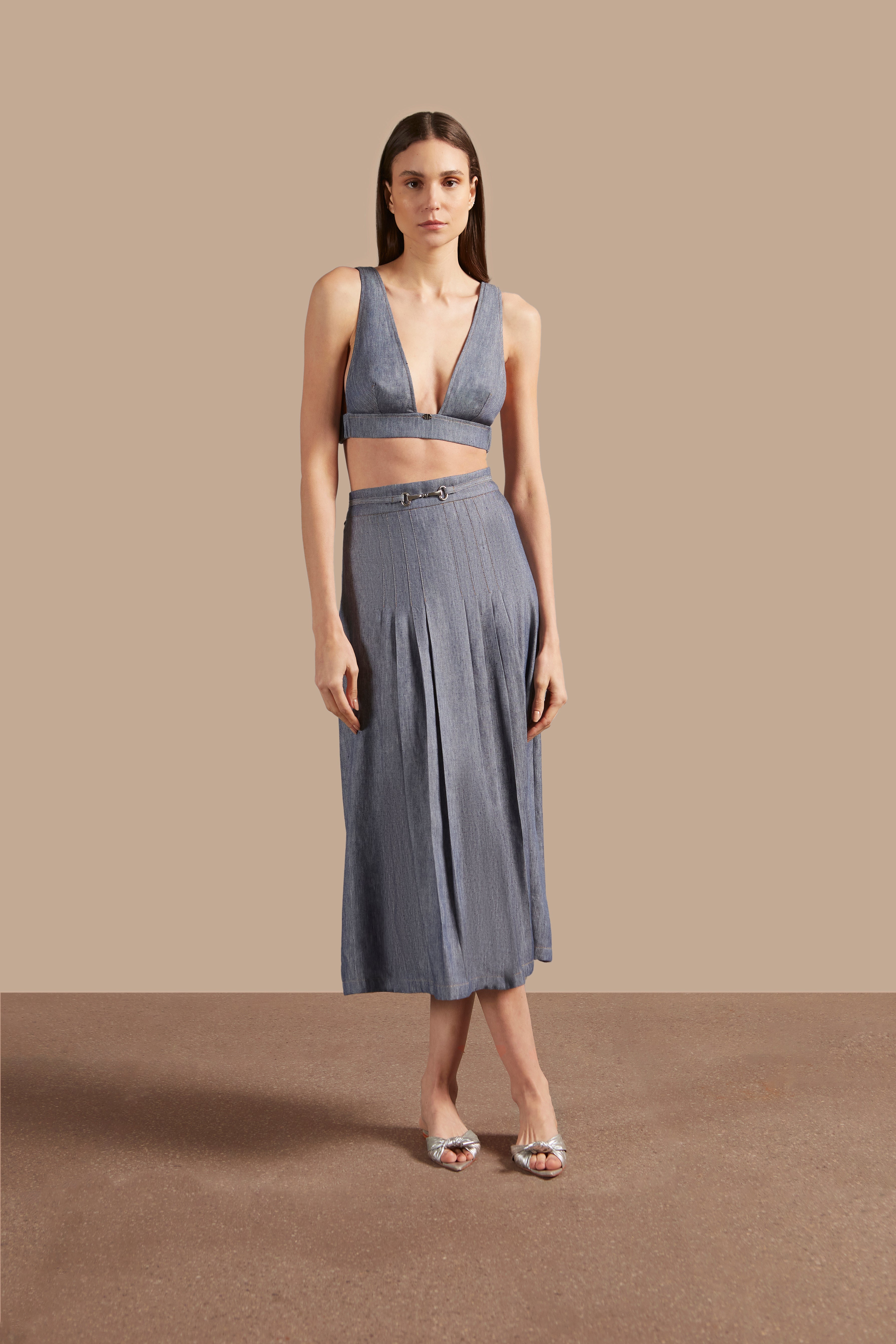 Front view of Adriana Degreas' Jeans Pleated Midi Skirt in a denim-inspired blue, featuring elegant pleats and a high-waist design.