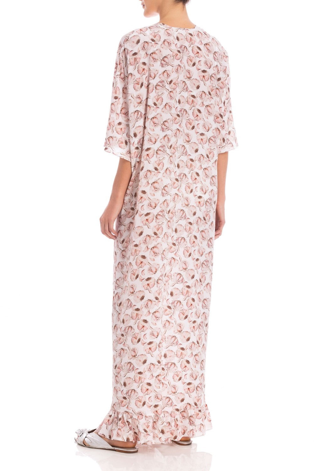 Model wearing the Aglio Long Kaftan With Knot showcasing the back of it's midi sleeved piece, with Aglio Print, on a silk fabric.
