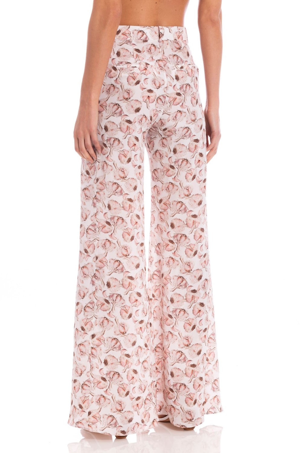 Model wearing the Aglio Wide Leg Pants showcasing the back of it's high-waited piece, with Aglio Print, on a silk fabric.