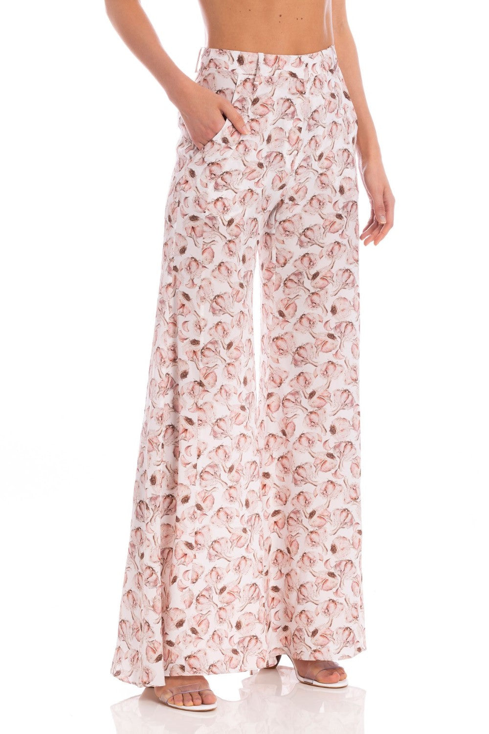 Model wearing the Aglio Wide Leg Pants showcasing the front of it's high-waited piece, with Aglio Print, on a silk fabric.