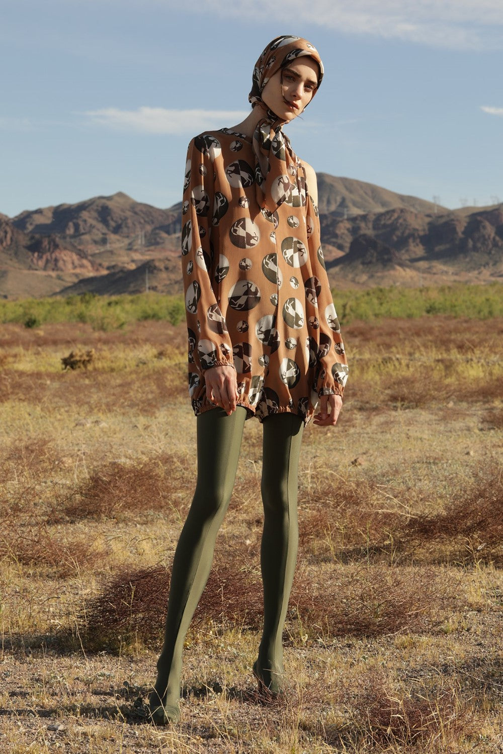 This silk horse pois playsuit is influenced by retro silhouettes