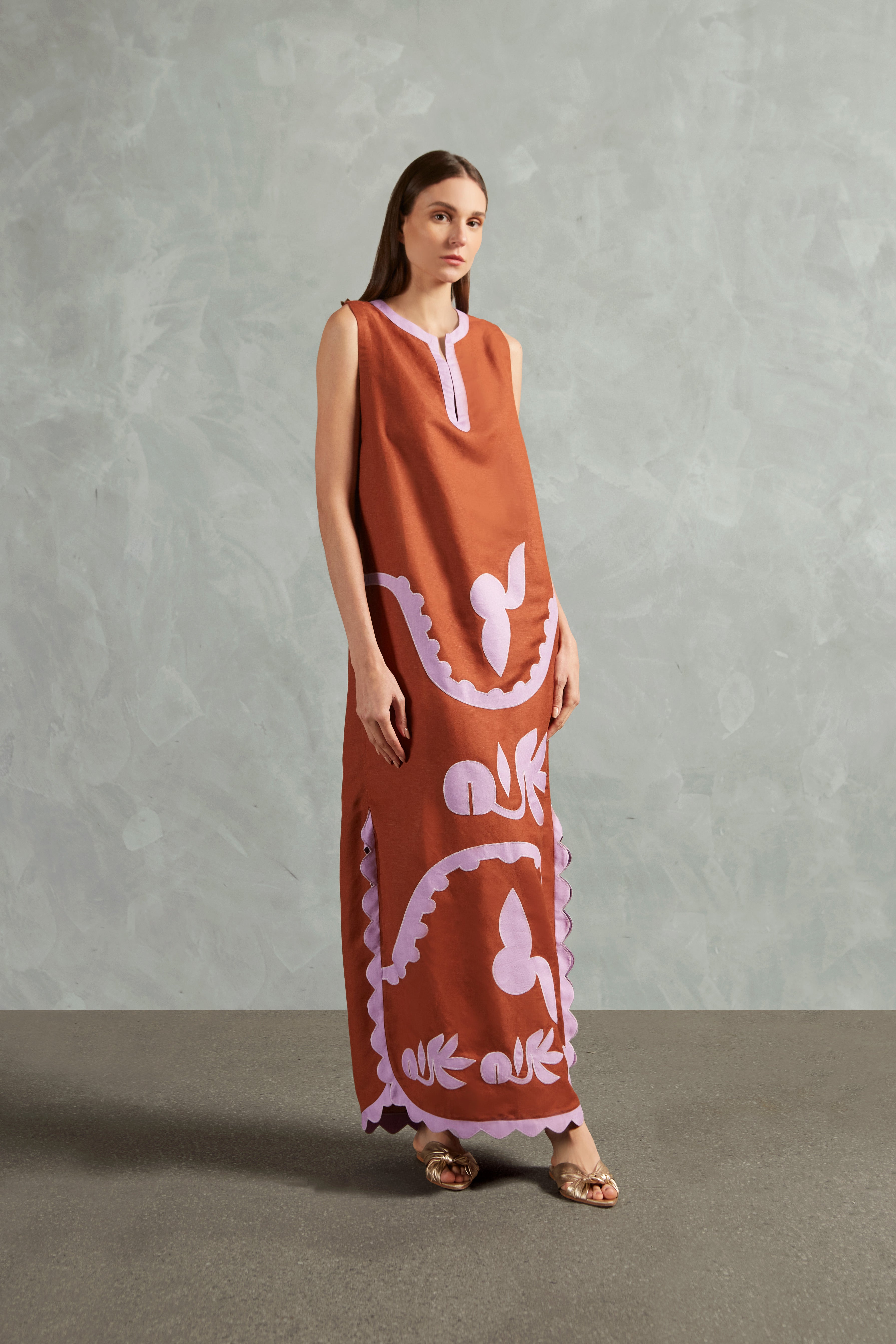 Model wearing the Appliqué Midi Tunic Front showcasing its Cognac and Lilac print on 55% Linen 45% Viscose fabric, styled for an afternoon look.