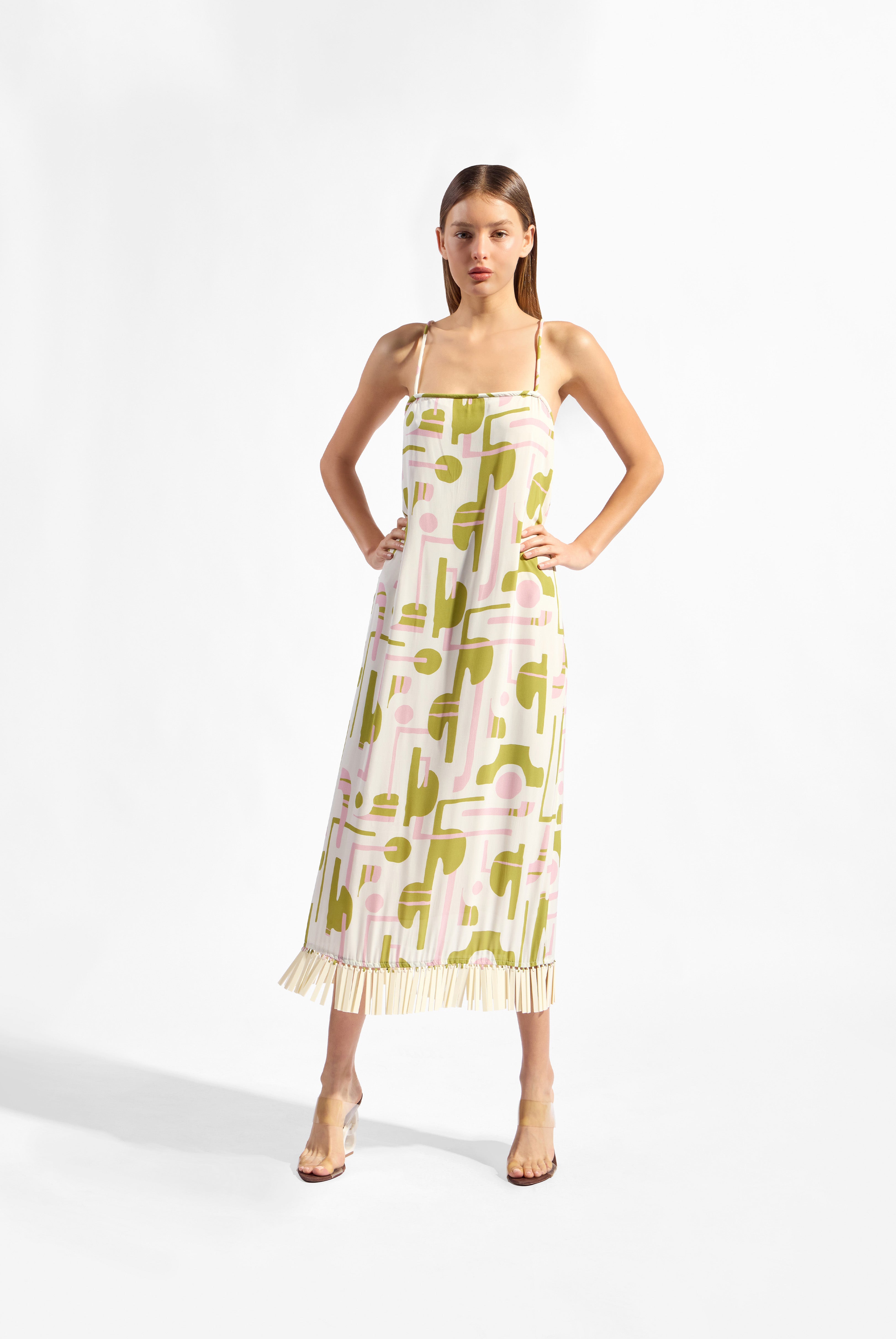 Model wearing the Balearic Acrylic Fringe Midi Dress front, showcasing its unique color made from 100% Viscose fabric, styled for an afternoon look.  