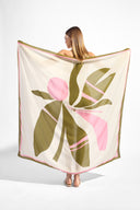 Model holding the Balearic Panneau, showcasing its floral green and pink print on 100% viscose fabric.