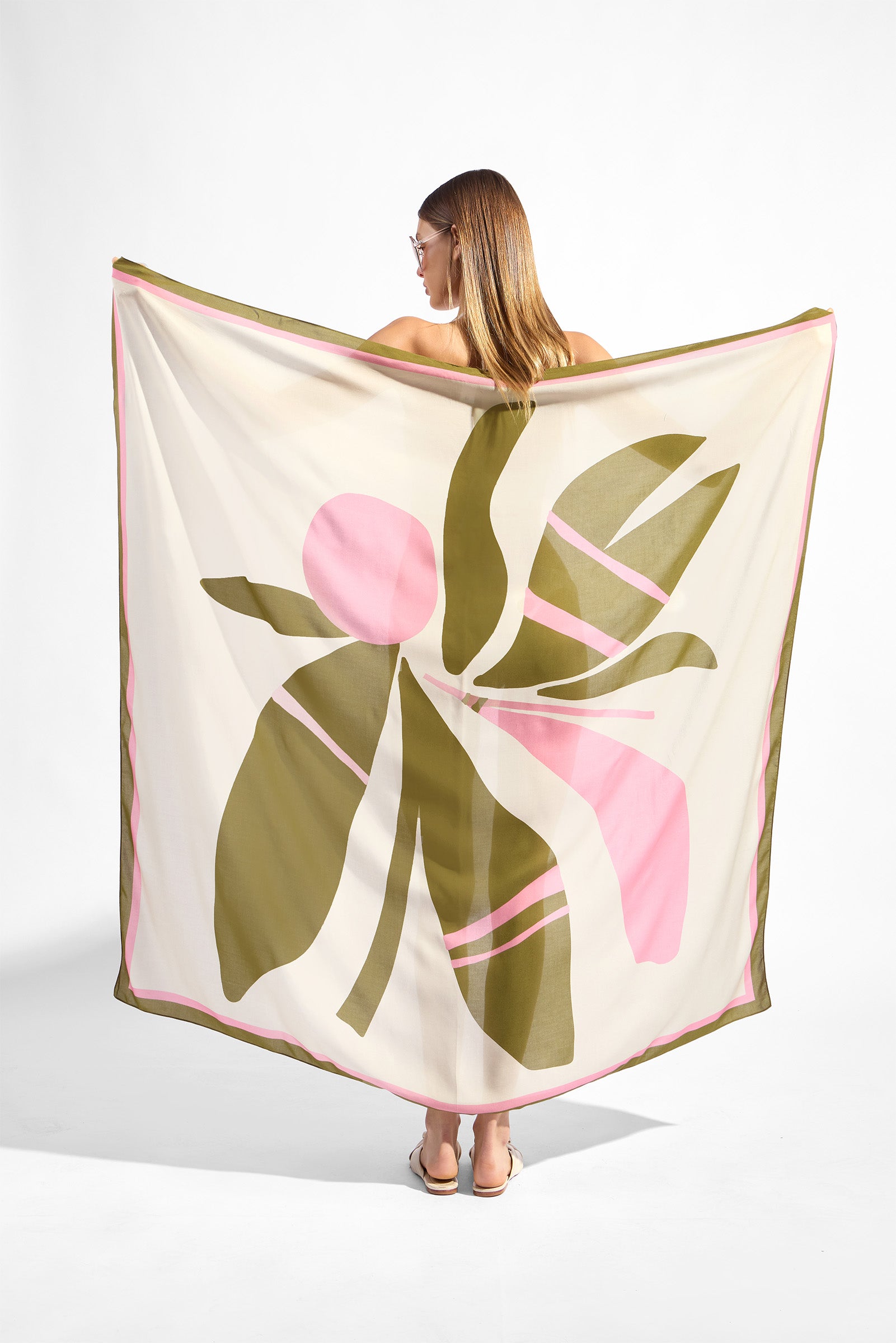 Model holding the Balearic Panneau, showcasing its floral green and pink print on 100% viscose fabric.