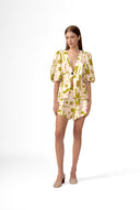 Model wearing the Balearic Puff Sleeve Blouse front color unique made with 56% viscose 44% Linen, styled for resortwear look