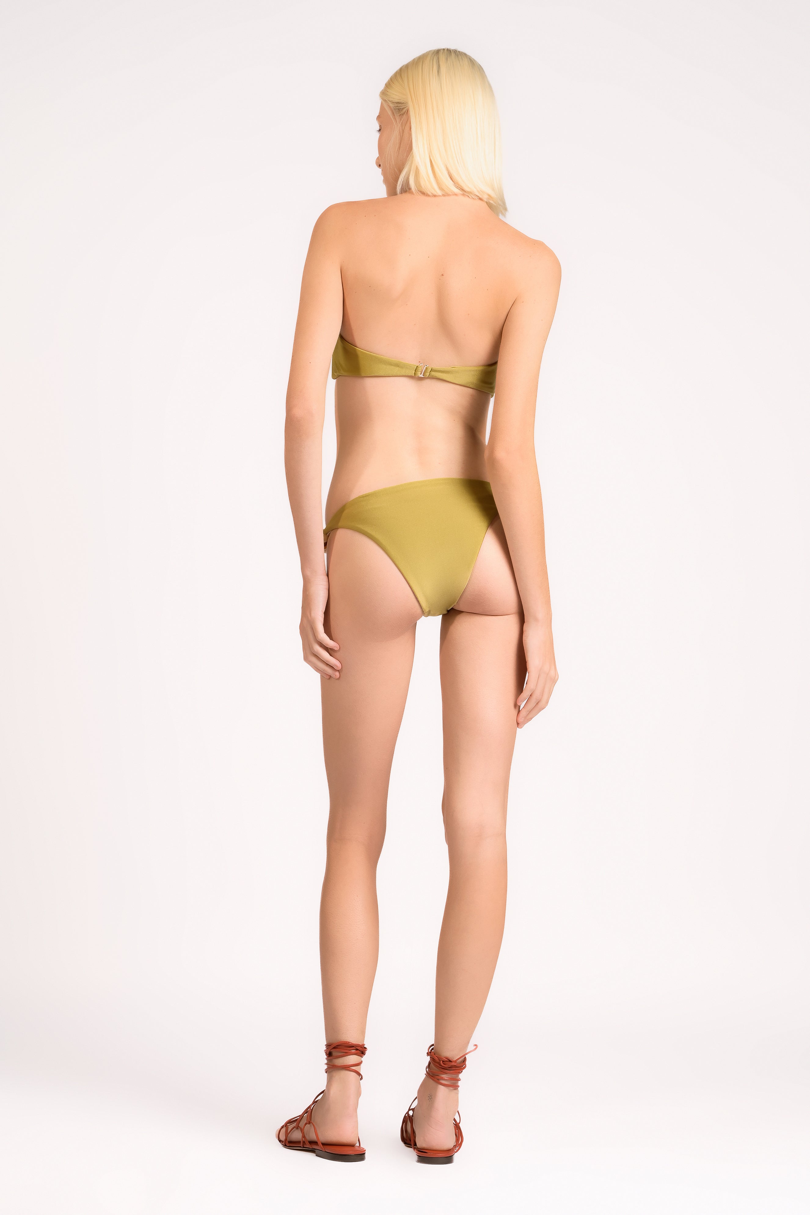 Model wearing the Bandeau Beaded Bikini Set back color pistachio, made from 85% polyamide 15% elastane, styled for beachwear look 