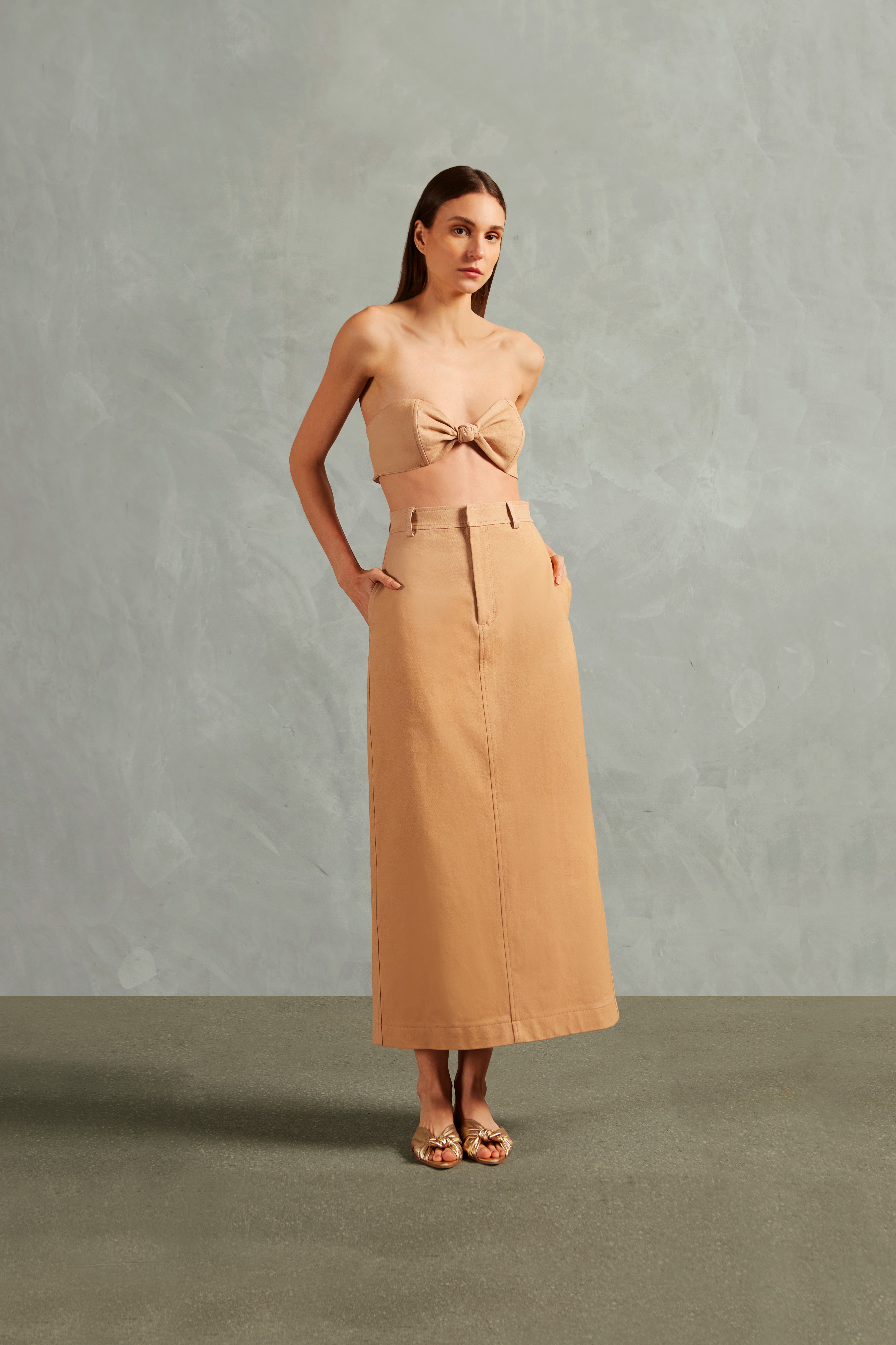 Model wearing the Bicolor Solid Midi Skirt Front showcasing its Beige print on 100% Cotton fabric, styled for an afternoon look.