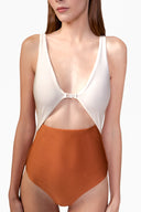 Model wearing the Bicolor Cut-Out Swimsuit detail color cognac, made from 85% polyamide 15% elastane, styled for a beachwear look