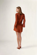 Model wearing the Bicolor Front-Tie Top back color cognac made with 56% viscose 44% Linen, styled for resortwear look