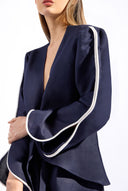 Model wearing the Bicolor Front-Tie Top detail color navy made with 56% viscose 44% Linen, styled for resortwear look