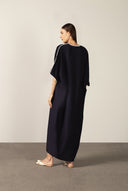 Model wearing the Bicolor Maxi Kaftan back color navy made with 56% viscose 44% Linen, styled for resortwear look