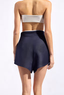 Model wearing the Bicolor Shorts  back color navy made with 55% viscose 45% Linen, styled for resortwear look