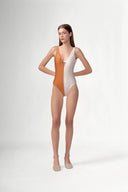 Model wearing the Bicolor Straps Swimsuit front color cognac, made from 85% polyamide 15% elastane, styled for a beachwear look